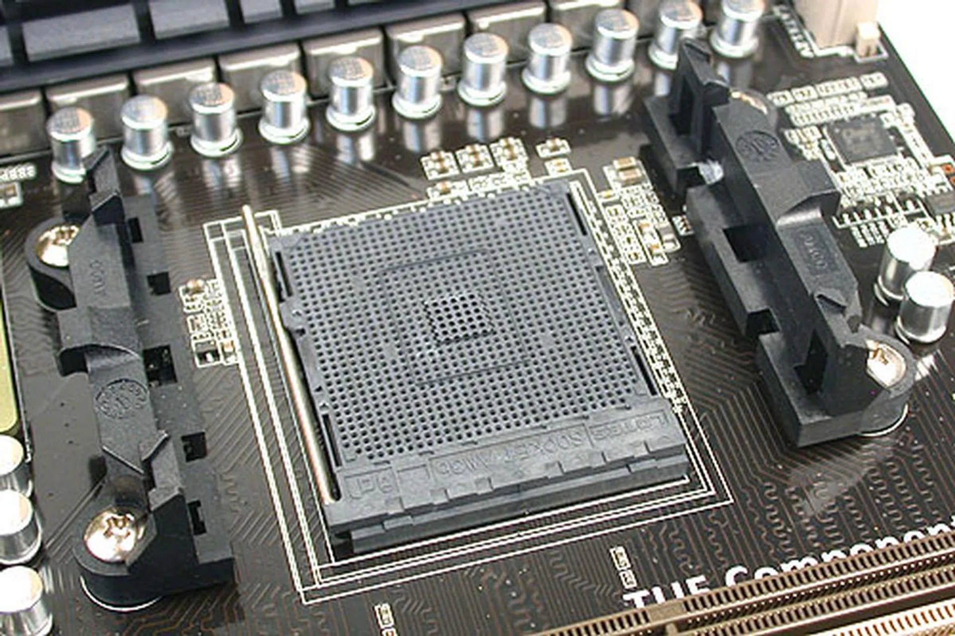 The new AM3b slot that supports the new AM3+ processors. We were quite surprised to see that ASUS has taken out two sides of the heatsink mounting bracket surrounding the socket, but we suppose this was due to the lack of space. It certainly doesn't look like there is that much allowance for larger third-party coolers.