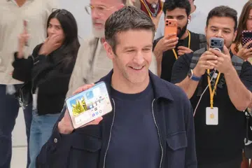 John Ternus holding iPhone Duo