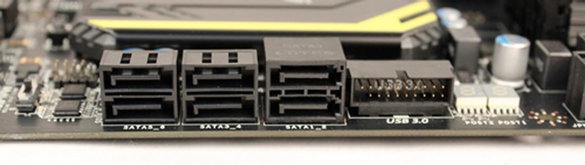 The pair of SATA 6Gbps connectors is distinctive enough from the four SATA 3Gbps ones, even though they are of the same color. A USB 3.0 front panel expansion header is placed next to the SATA 6Gbps connectors.