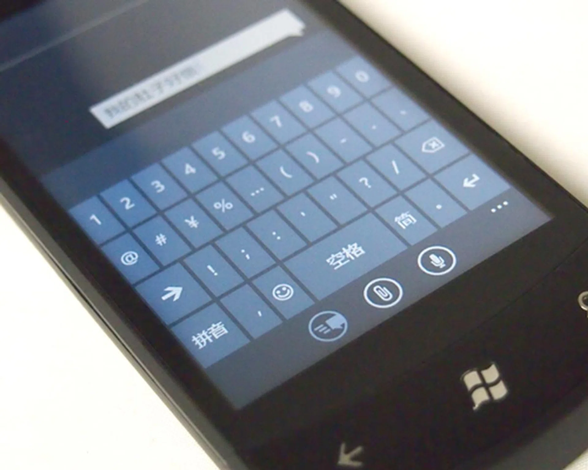 After choosing additional language inputs via Settings > Keyboard, you can simply switch between the languages on your keyboard with a tap of the button.