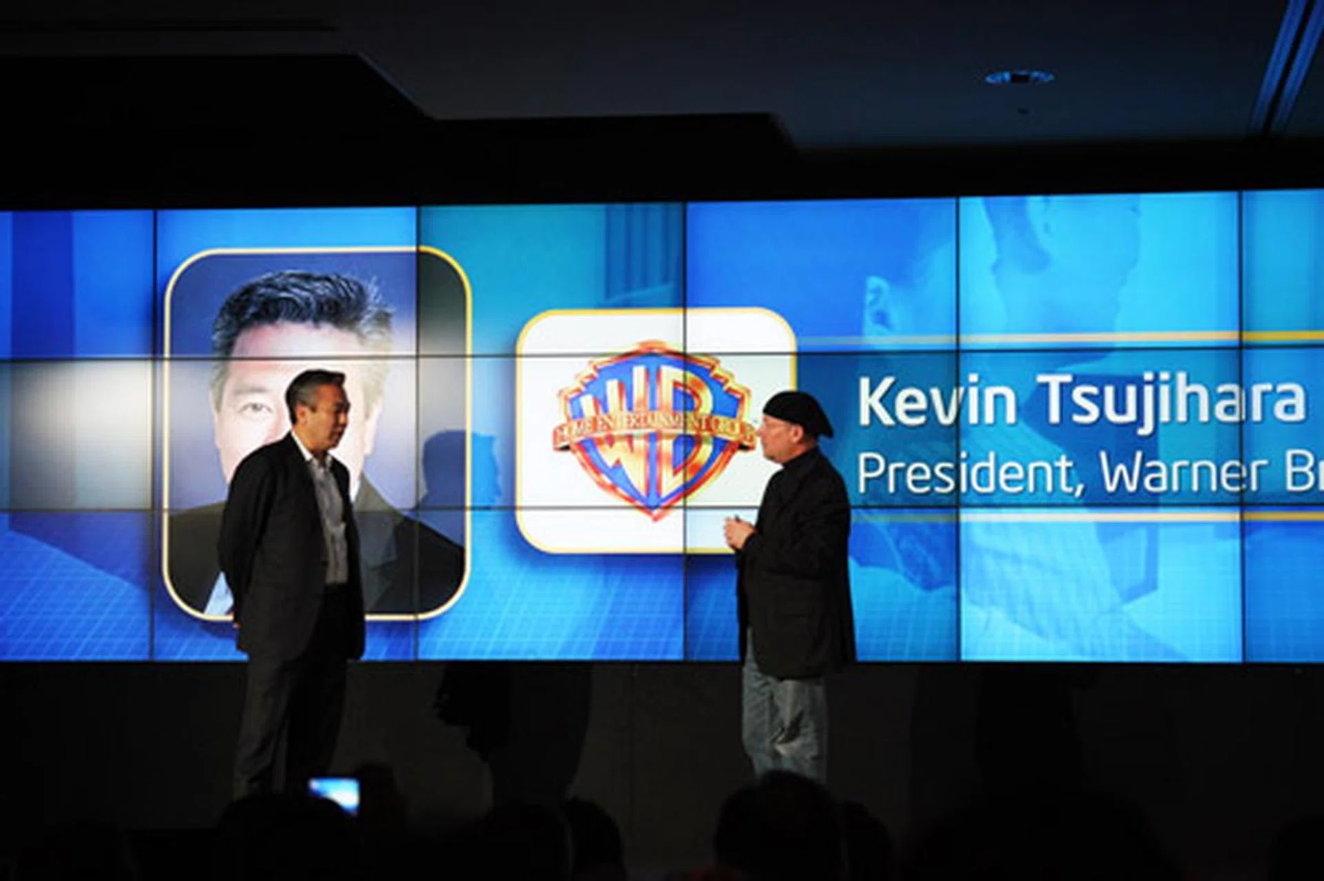 Kevin Tsujihara, Warner Home Entertainment Group President (left), explains to Mooly Eden, vice president and general manager, PC Client Group at Intel (right), the importance of Intel Insider in the delivery of content securely through the internet.