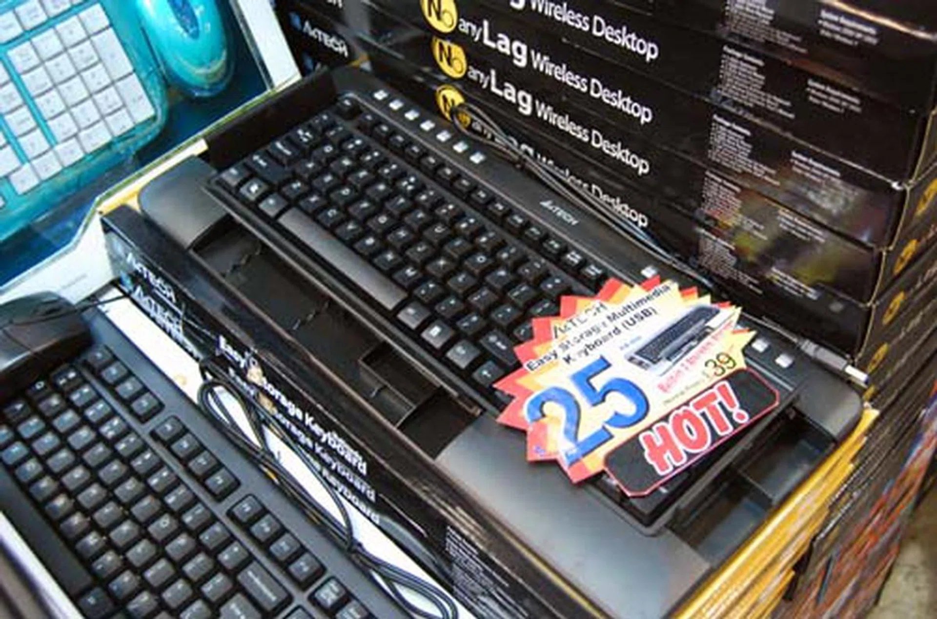 A4Tech has a keyboard that allows you to store stuff inside, and comes with laser inscribed keys, spill proof structure for just a measly $25.