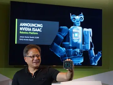 NVIDIA CEO Jensen Huang holding out the just introduced Jetson Xavier.