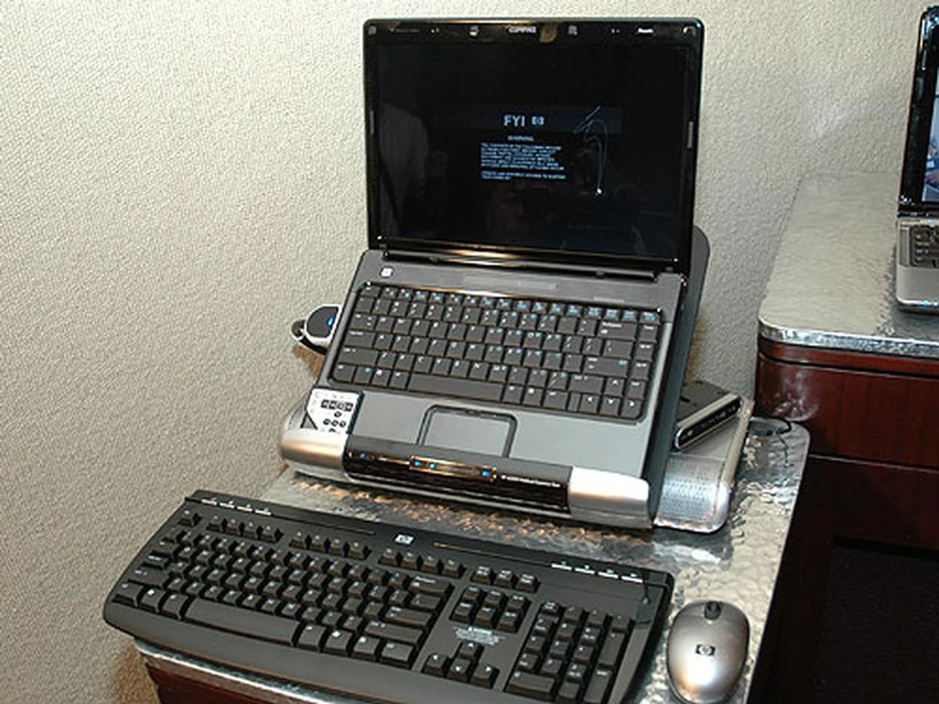 The new Compaq Presario V3000 series Notebook PC docked on the HP xb3000 Notebook Expansion Base.
