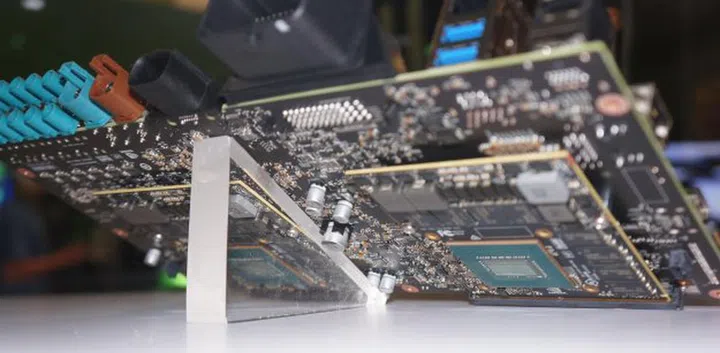 On the rear side of the board, you can catch a glimpse of the two discrete Pascal GPUs used to augment the Tegras on the front.