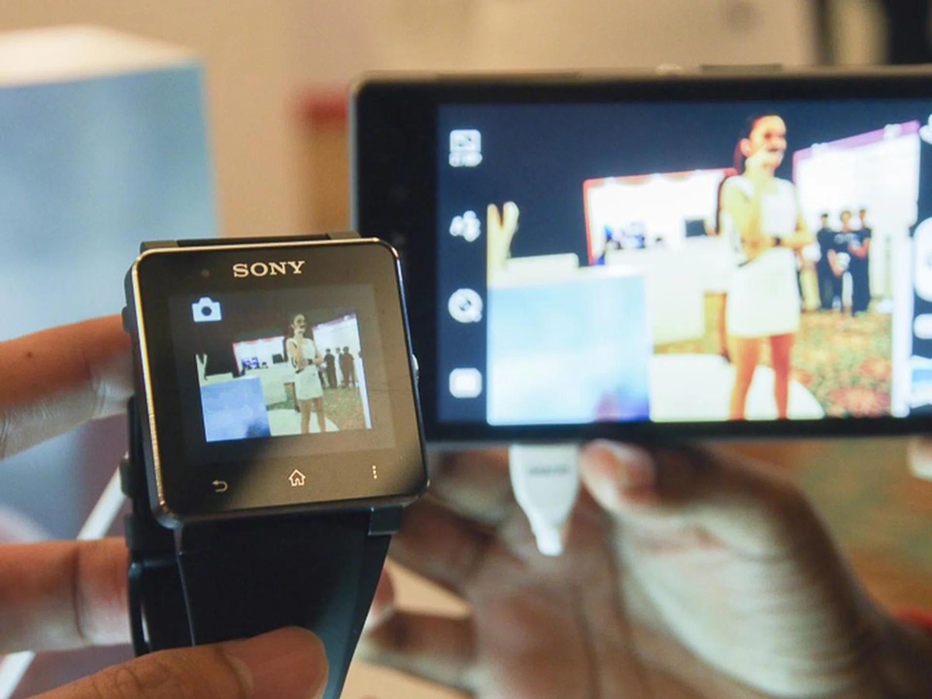 You can view a live feed from the smartphone's camera and even snap a shot using the SmartWatch 2.