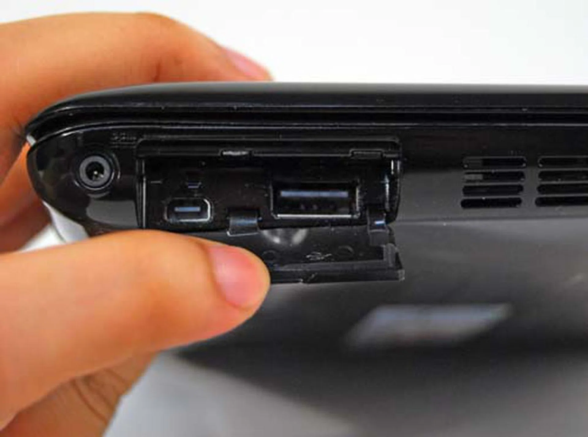 On the left side of the unit is another USB port together with a special port for a VGA out. You'll need to use the coverter cable that's hidden at the bottom of the unit.