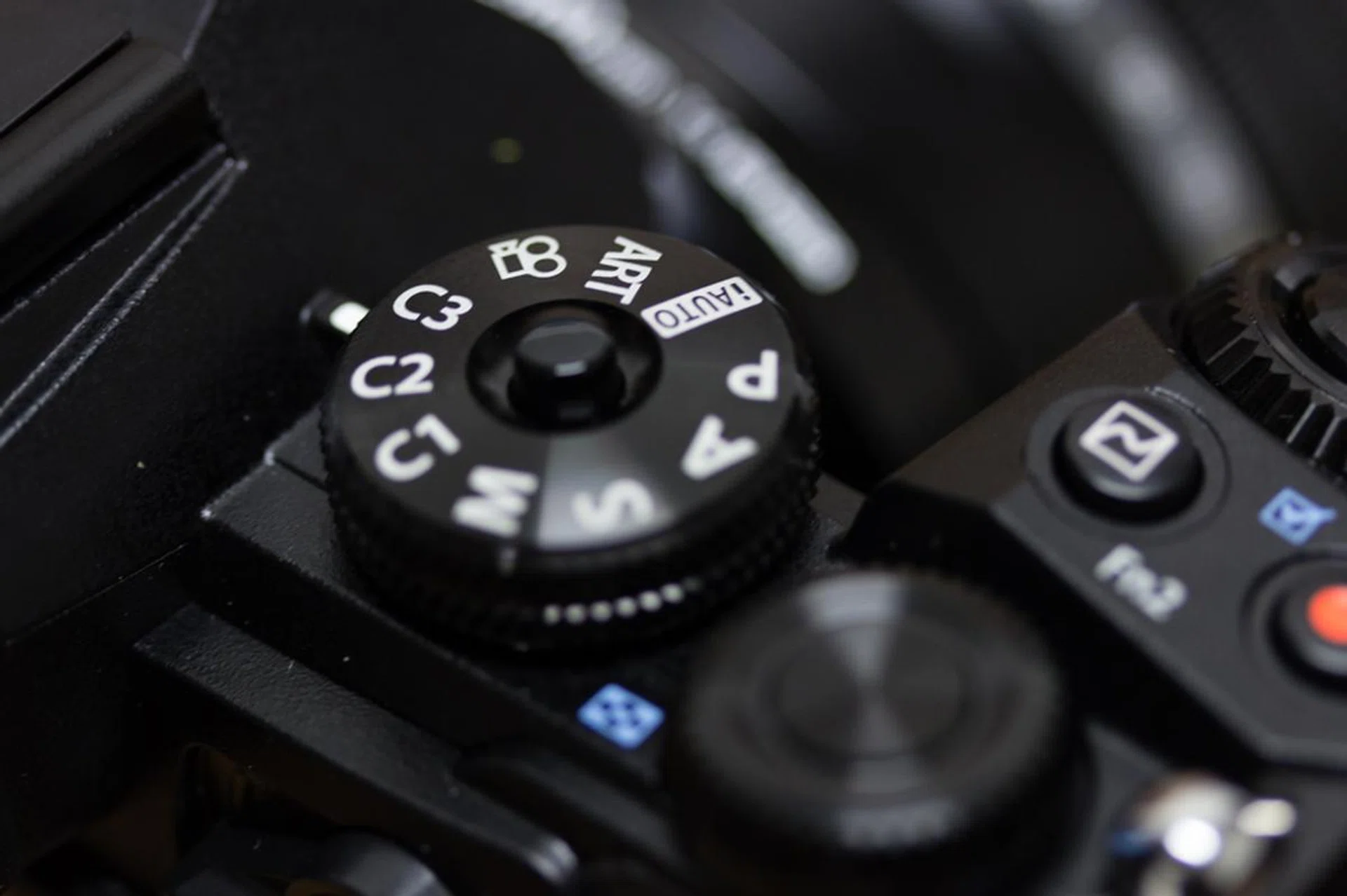 You can now lock down the Mode dial with the center lock button, but I wish there was a way to lock down the entire camera as well.