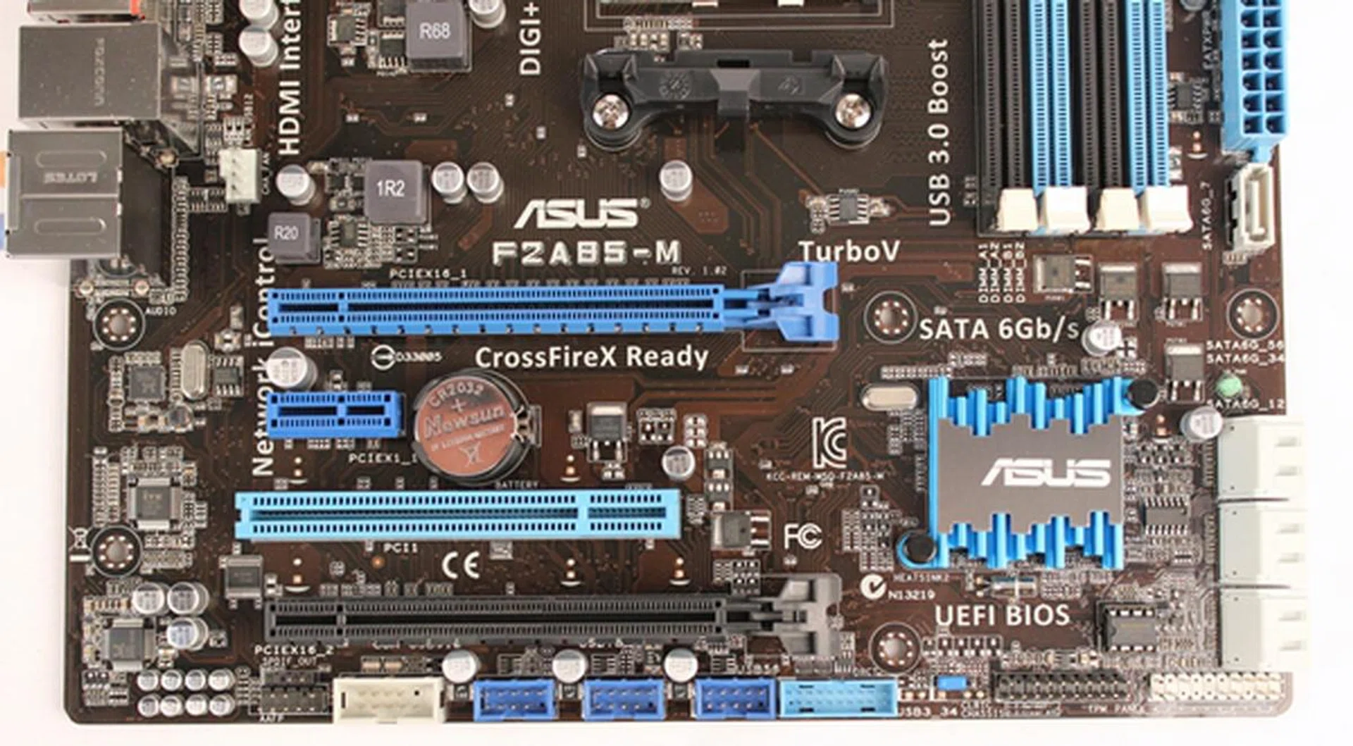 The bottom edge of the ASUS F2A85-M sports three USB 2.0 headers; they are the ones in bright blue color. This ASUS board has the most USB 2.0 headers, even beating out the normal ATX sized boards in our lineup. Also seen in this photo is the only heatsink across the entire board that's used for cooling the chipset.