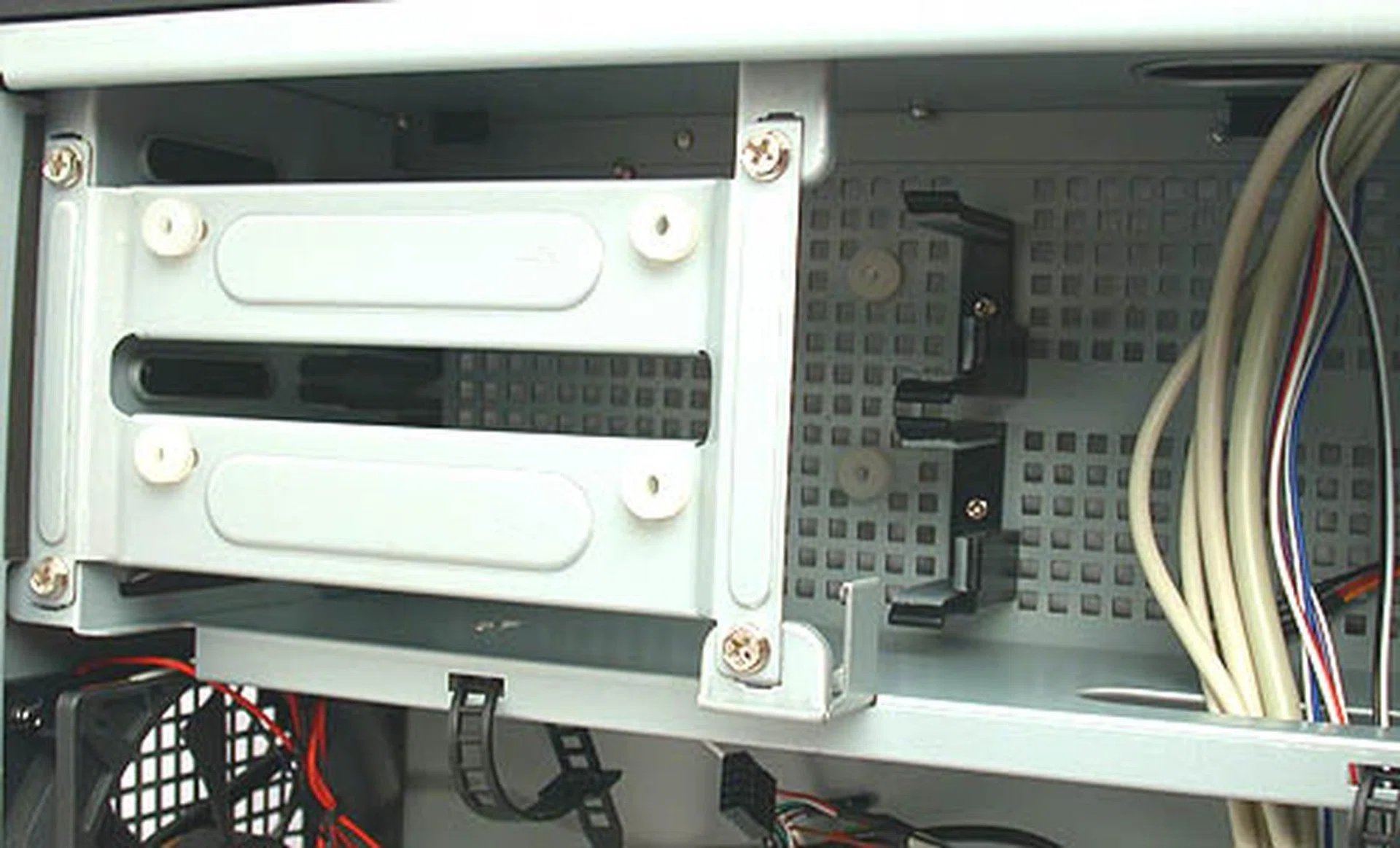 The hard drive cage has to be removed by unscrewing the four screws before installation. There are only two bays so plan to get larger hard disks before hand. Grommets are used to reduce noise through vibration while the vents help to ensure that your drives stay healthy. 