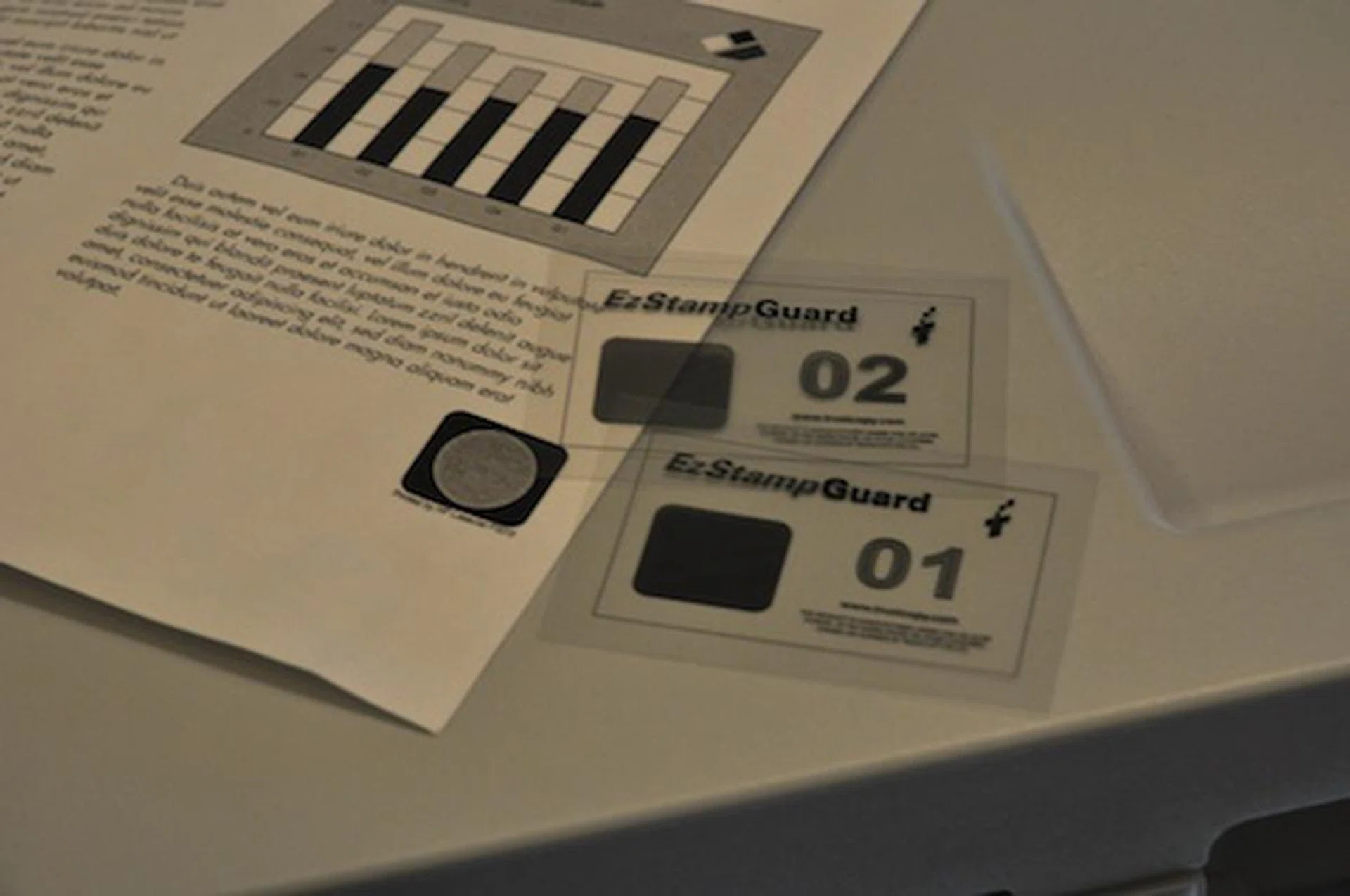 EzStampGuard prints a square watermark stamp on the bottom right of the printed page and the hidden image can only be seen using unique transparent key films.