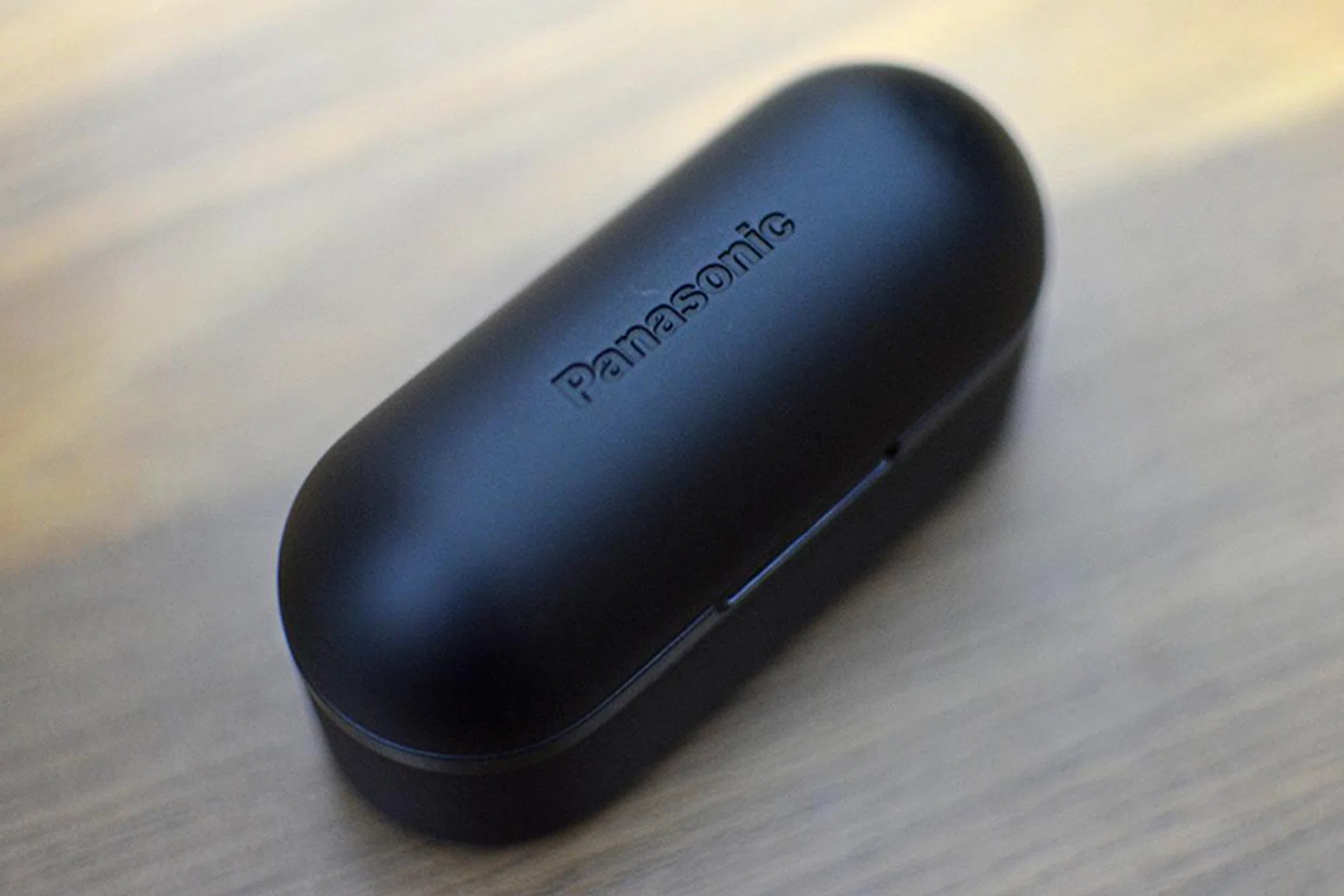 The embossed logo on the charging case's lid is barely visible.