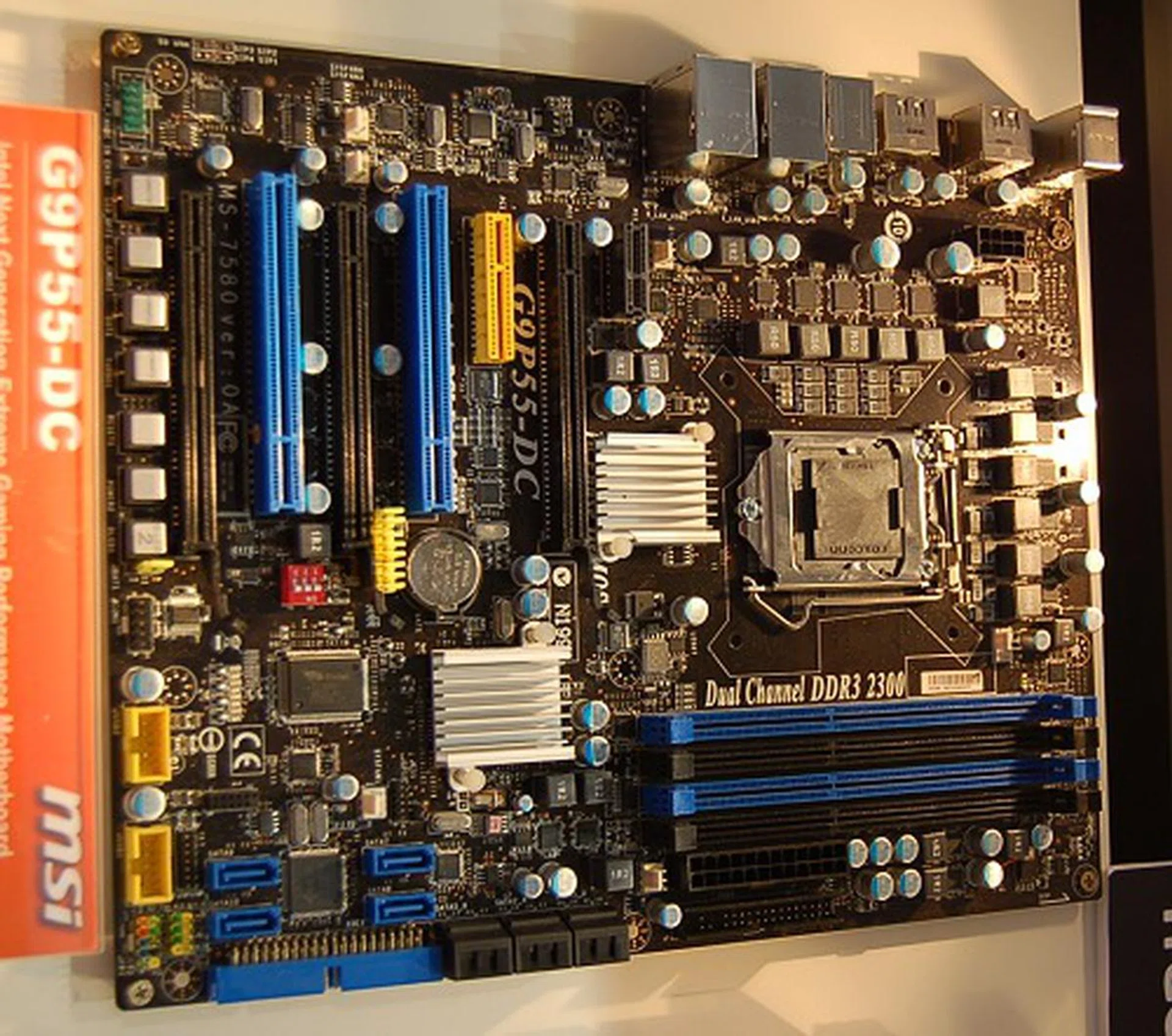  This is a higher-end P55 motherboard, the G9P55-DC. It has an additional open-ended PCIe X4 slot, more SATA ports, a secondary chipset of unknown purpose at the moment, bundled with a hardware audio card and foregoes the VGA output for perhaps digital video outputs.  
