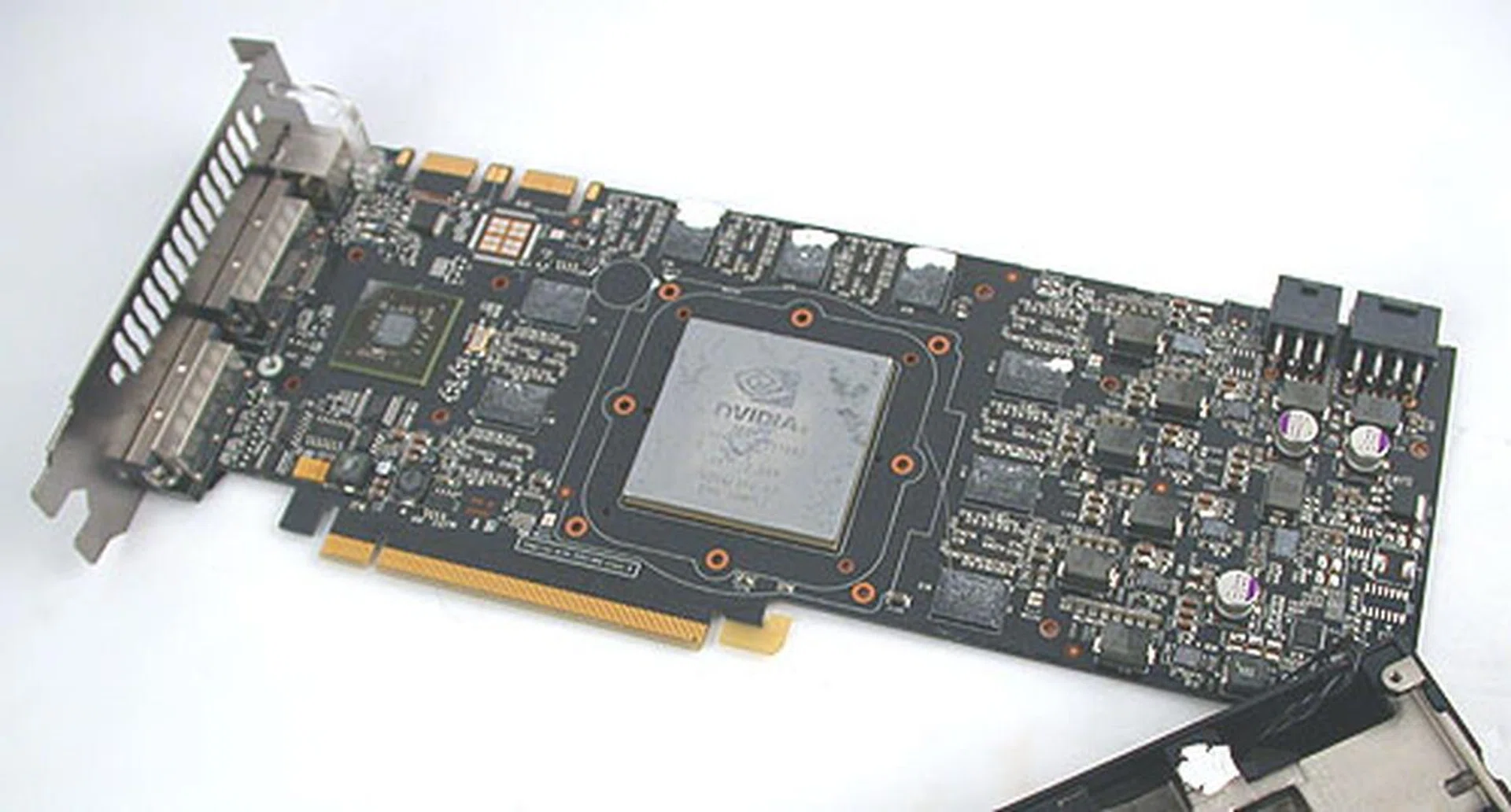 Removing the heatsink took quite a while, with many screws to overcome. But this allowed us to see the board layout, like the eight Hynix memory chips orbiting the huge GTX 280 GPU on the forward face of the board.