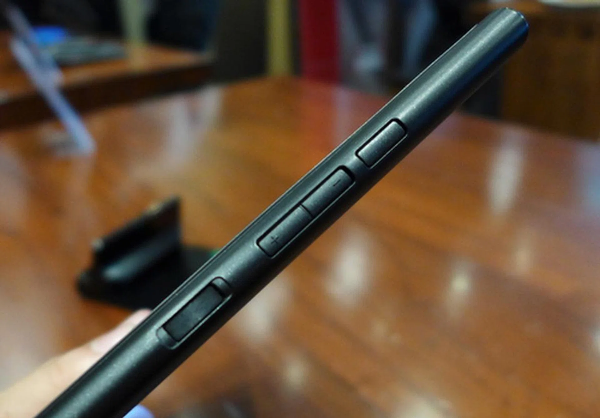 On the right profile of the machine, you will find the power switch and the volume rocker.