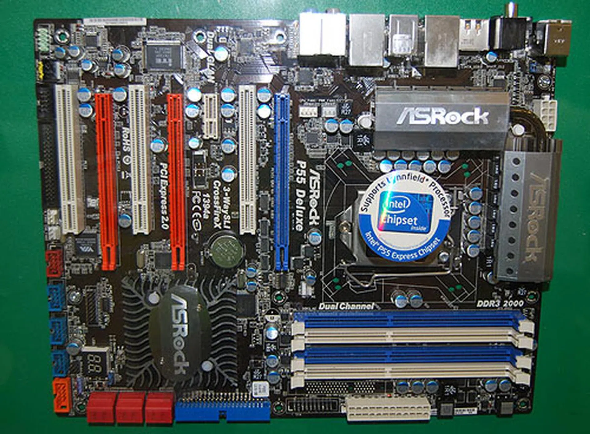 The world awaits Lynnfield as motherboard vendors like ASRock all display their readiness with P55 boards like this P55 Deluxe. This 12-phase equipped model can support up to 3-way multi-GPU rigs and has dual Gigabit LAN. Not too shabby for a mainstream board.