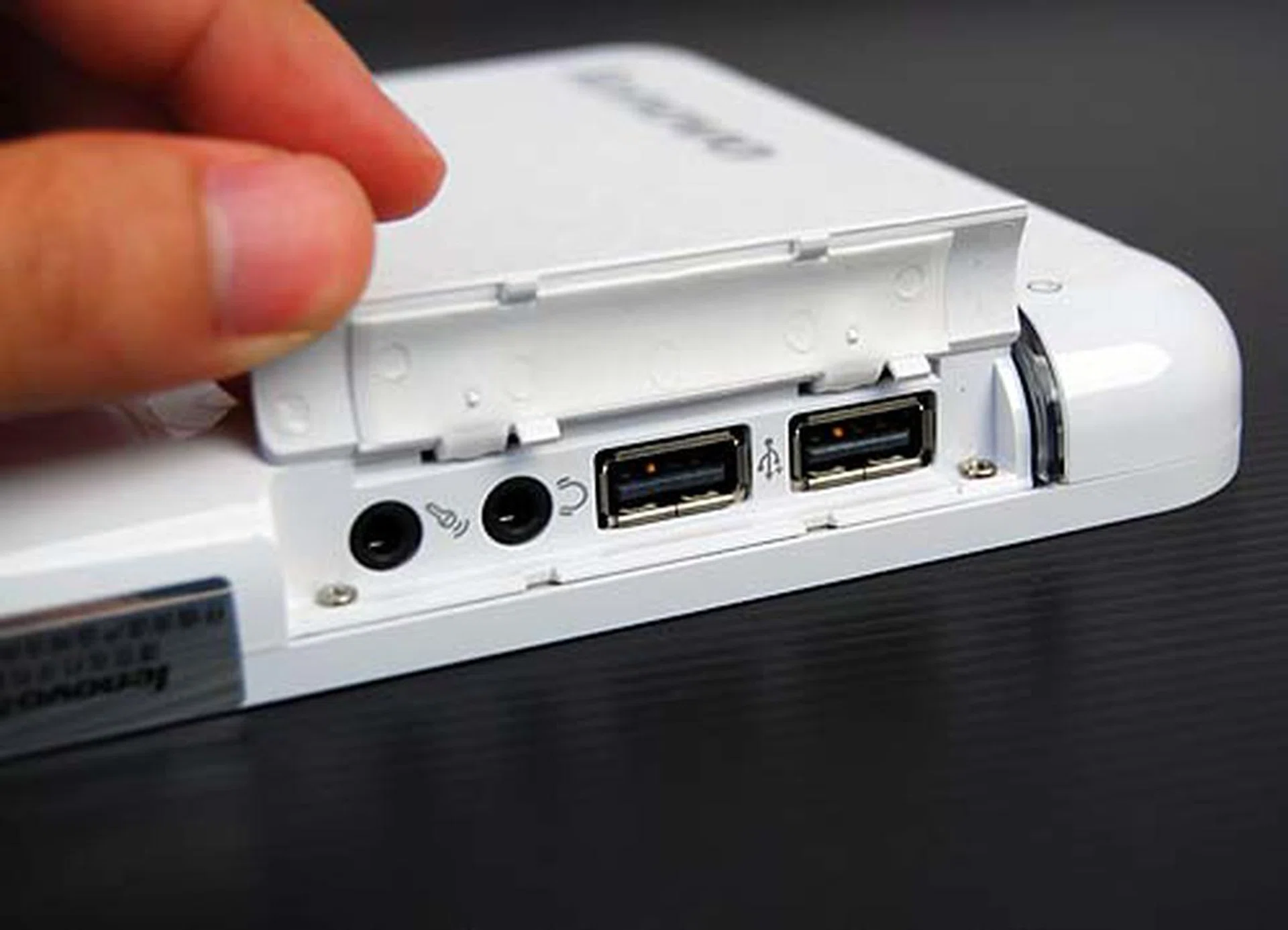 Located on the front and under a cover are additional USB ports and the audio jacks.