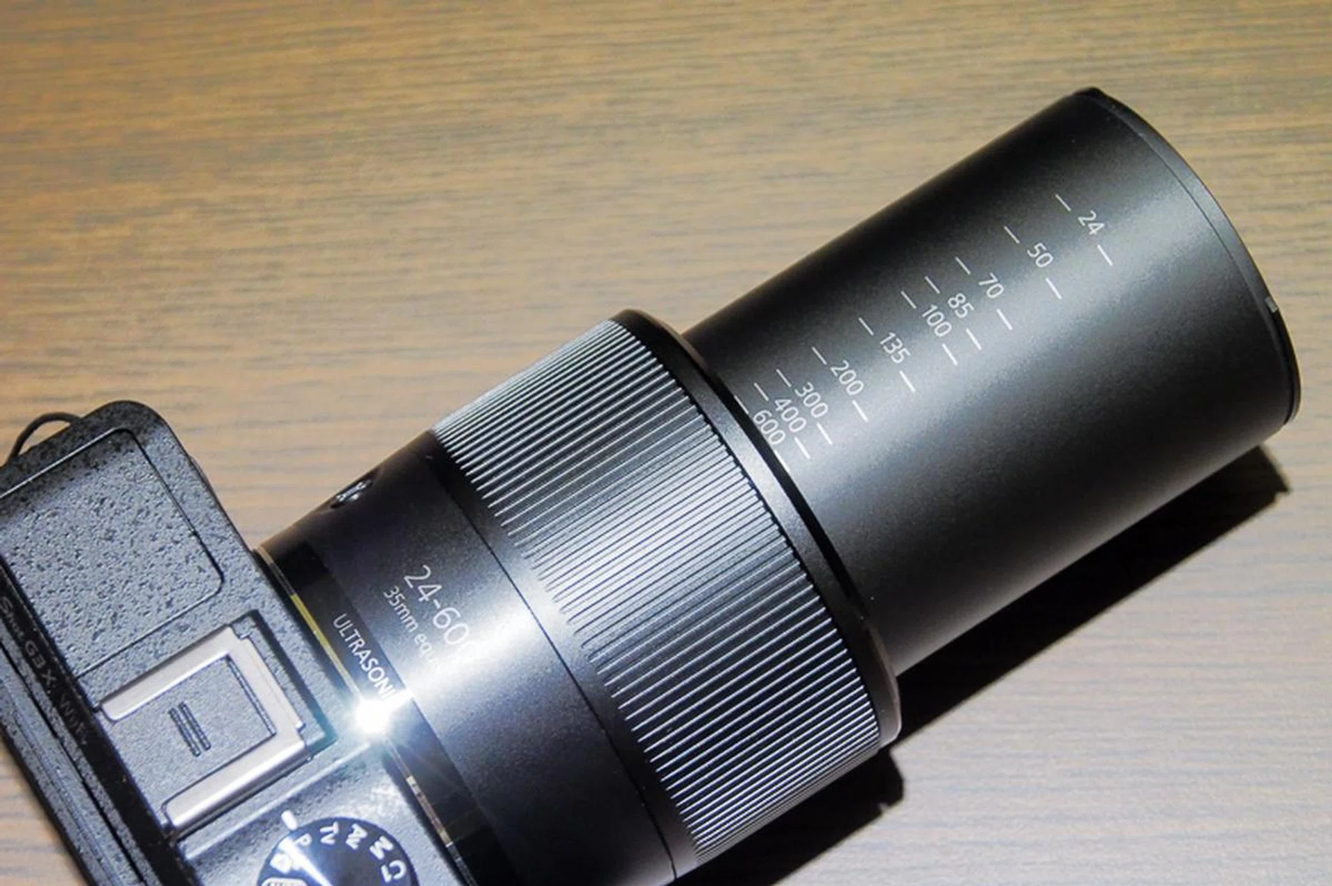 You can set the camera to use 'step zoom'; when you turn the zoom toggle, the lens will quickly go through the marked focal lengths.