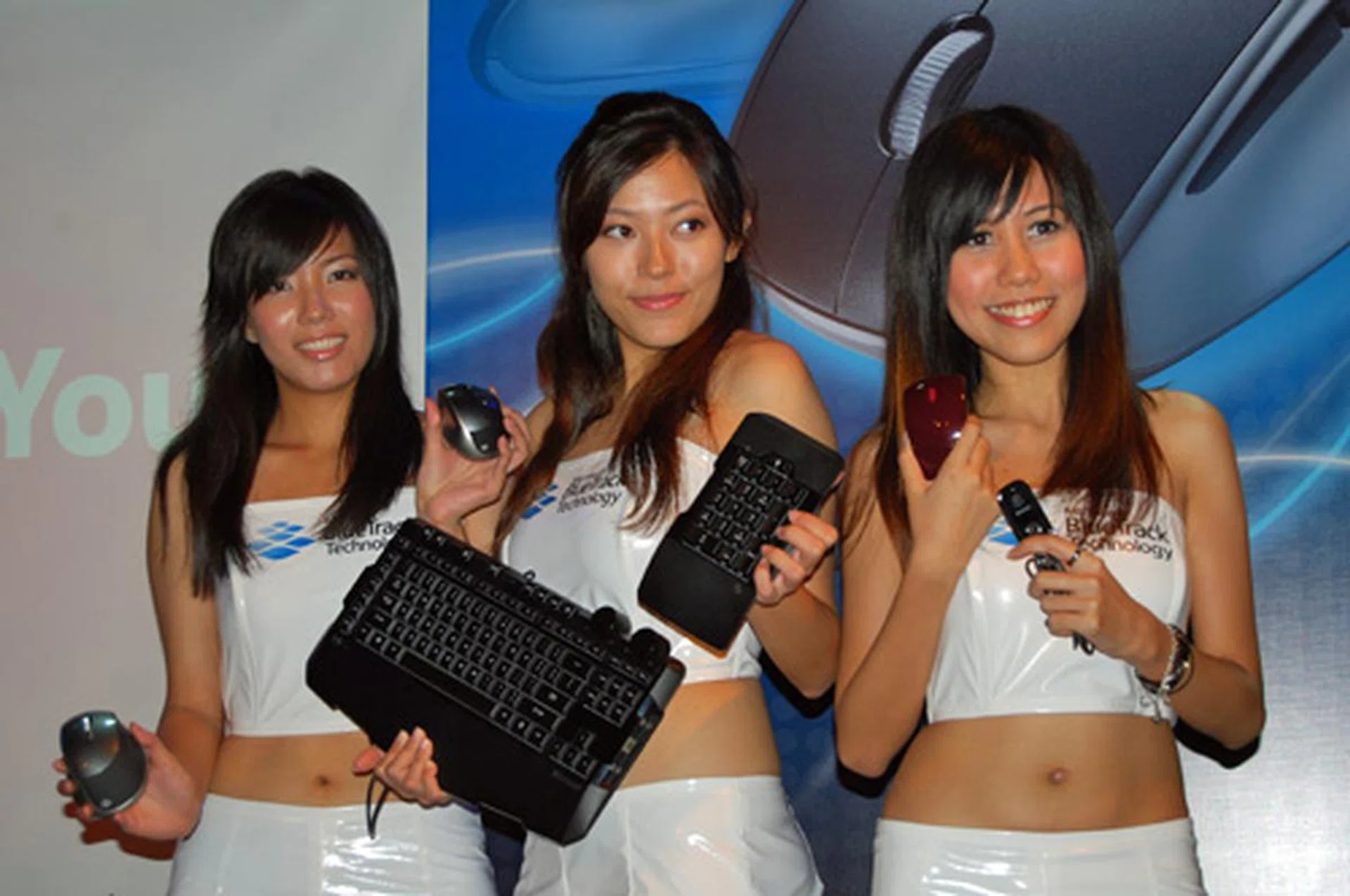  These pretty ladies happily showing off Microsoft's latest range of peripherals.  