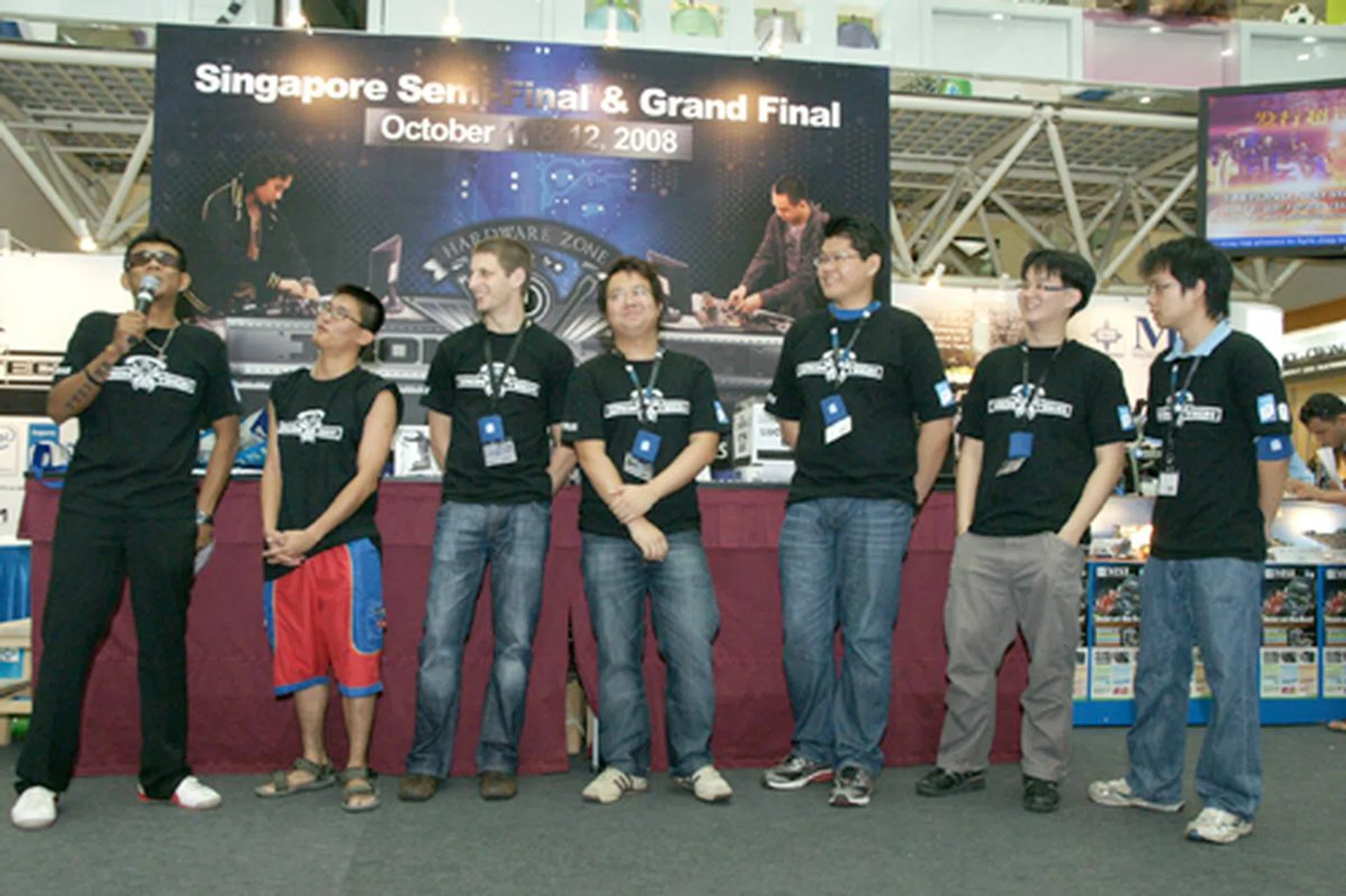  Our emcee for the day introduces the six contestants, striving for the privilege to duke it out with their fellow regional overclockers in the Iron Tech 2008 Grand Finals. Second from the left to right: Ng Soon Aik, Tim Marshall, Jeremiah Ong, Jeremy Chew, Chen Tianyi and Randy Hong.  