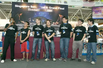  Our emcee for the day introduces the six contestants, striving for the privilege to duke it out with their fellow regional overclockers in the Iron Tech 2008 Grand Finals. Second from the left to right: Ng Soon Aik, Tim Marshall, Jeremiah Ong, Jeremy Chew, Chen Tianyi and Randy Hong.  
