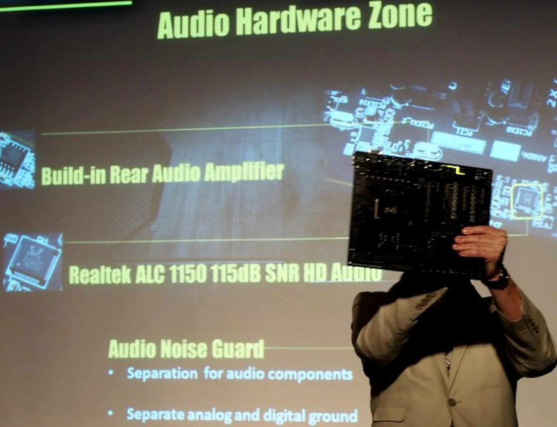 Colin Brix, Marketing Director, Gigabyte shines a light through a Gigabyte 9 Series motherboard to showcase their exclusive Audio Hardware Zone design (not related to HardwareZone) which removes all other signaling components from the audio section of the motherboard.