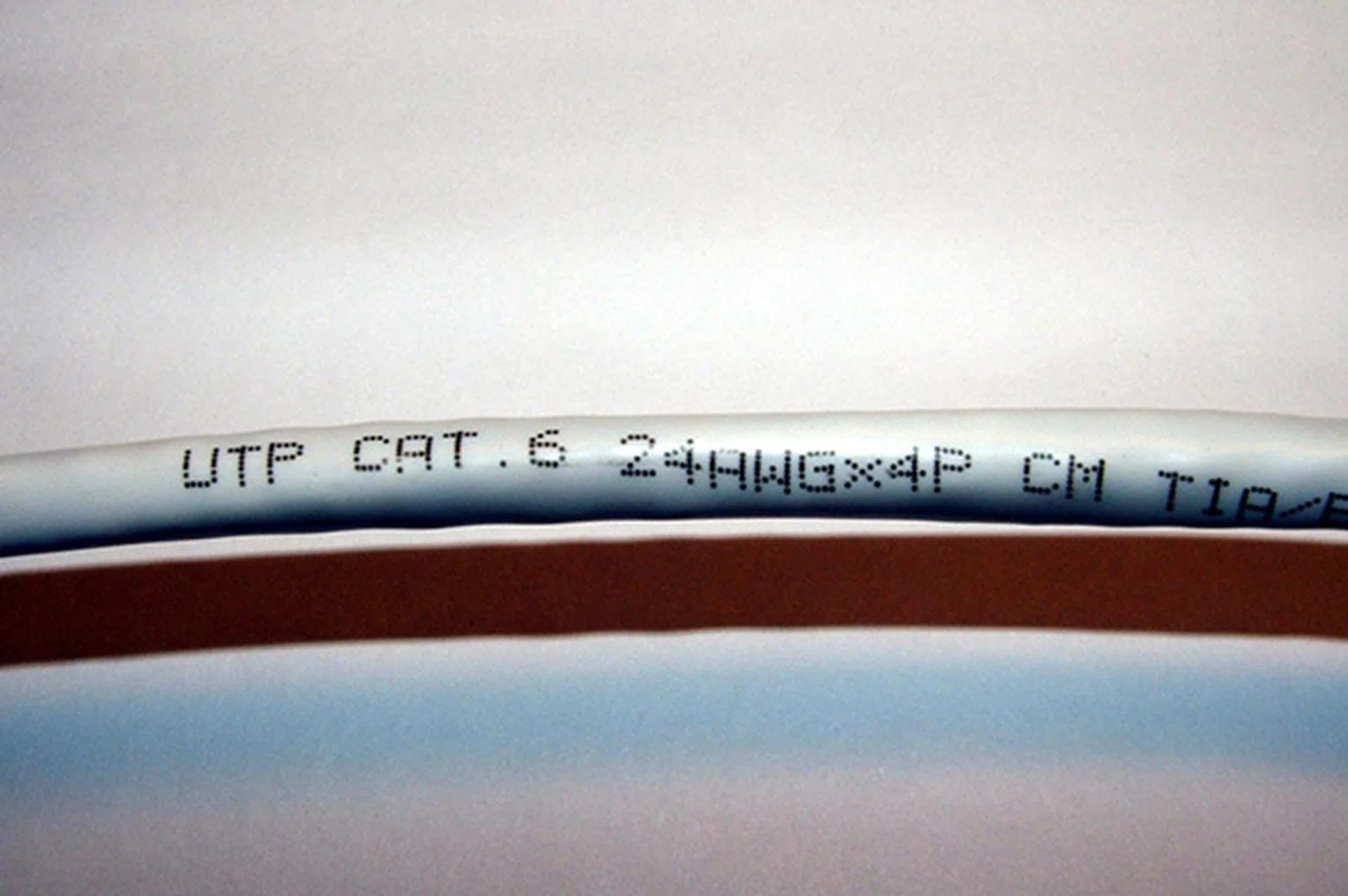 Since Cat 5 and Cat 6 cables are physically similar, look at the cable sheath to identify them. Image source: Donutey.