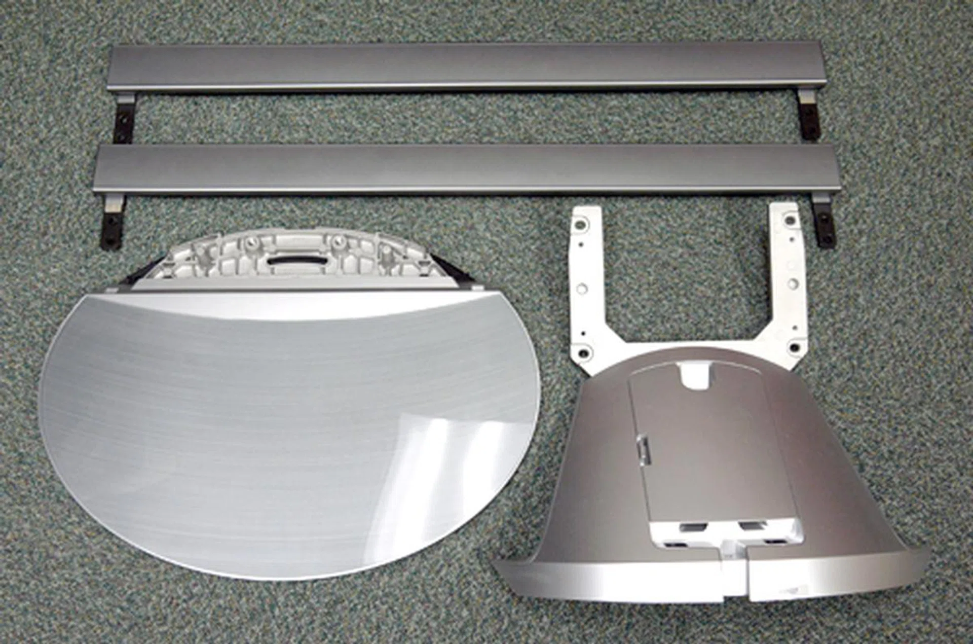Here are some of the accessories you'll need to put together to free-stand the Z1. Secure the pedestal (the one with prongs) to its ellipse base before you mount the panel. You'll also need four mounting brackets to attach the two side-bar speakers (shown on top) to the TV.