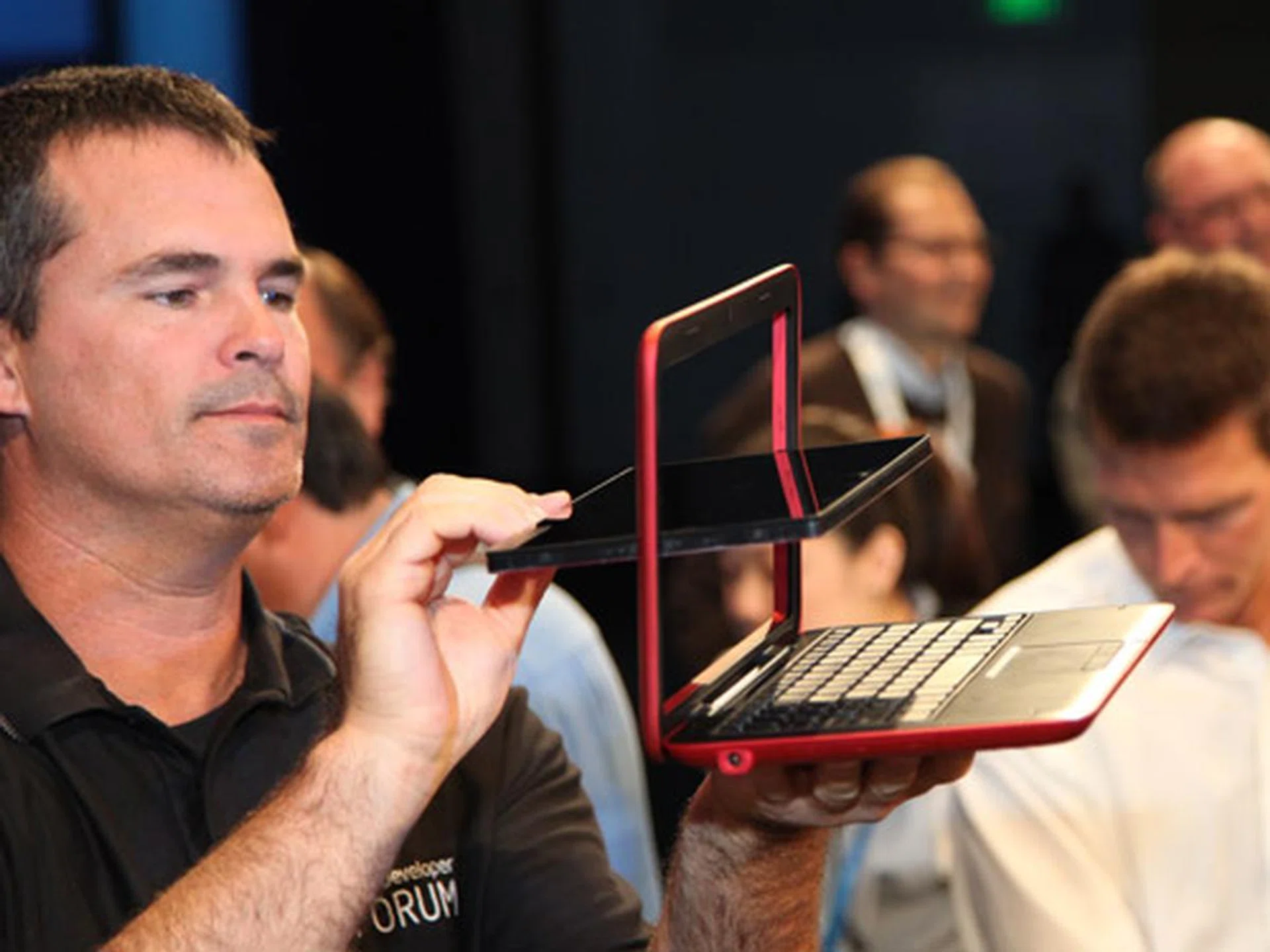 Intel booth staff demonstrating how the tablet could be converted into a netbook form factor.