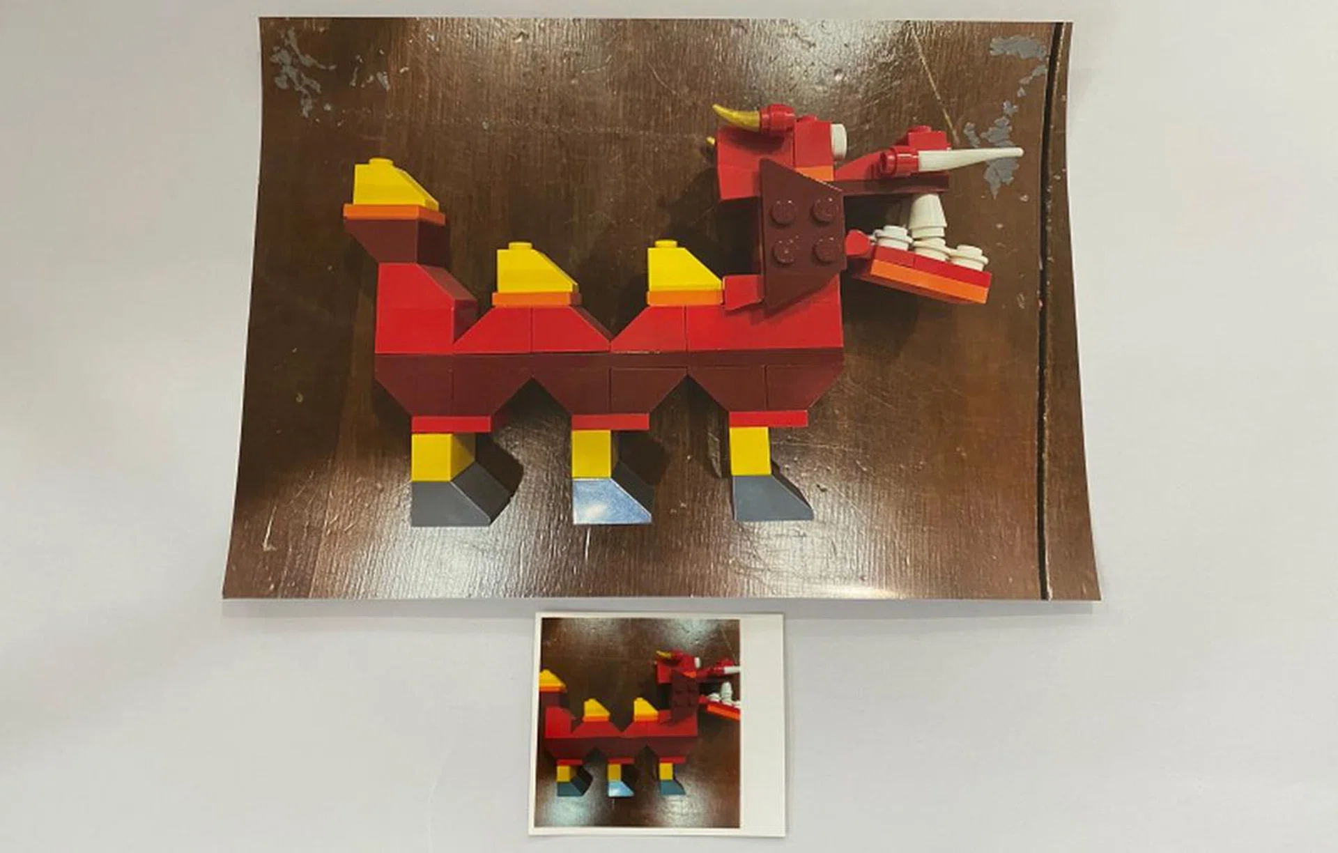 You can see the size difference between a regular A4 size paper print and the square paper printout of the QX10.