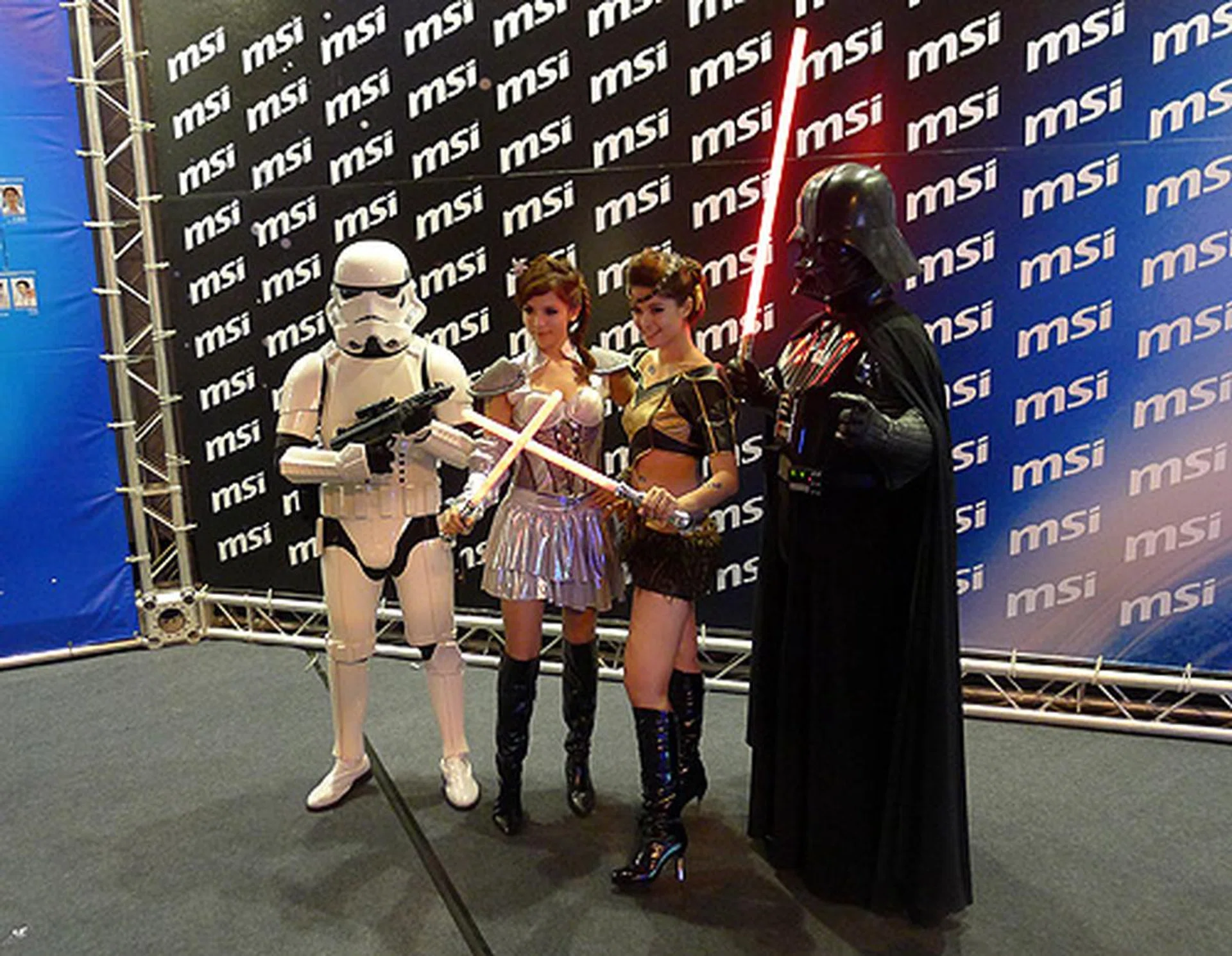 Darth Vader and the two Princess Leias pose for the camera.