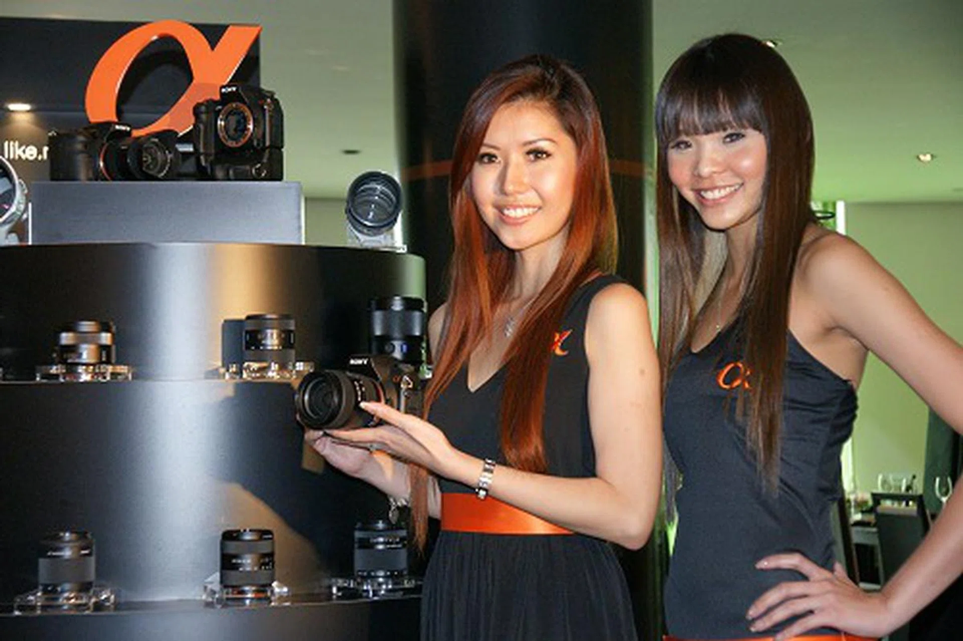  Models displaying the new camera in front of the Sony's full range of lenses that include four new additions from the Sony and Carl Zeiss partnership.  