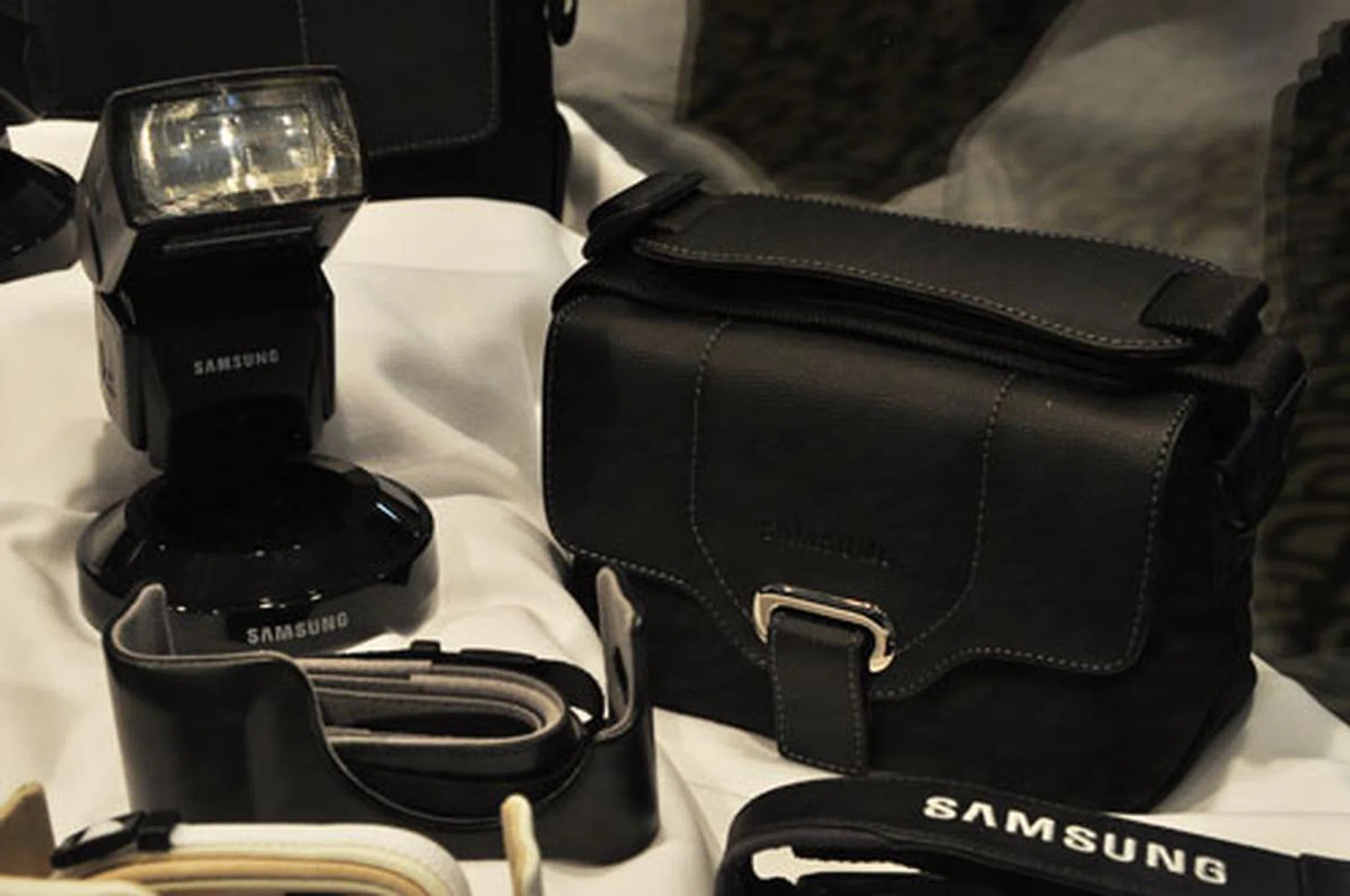 A Samsung SEF42A flash attachment (left) with flexible flash head and Samsung NX camera bag (right).