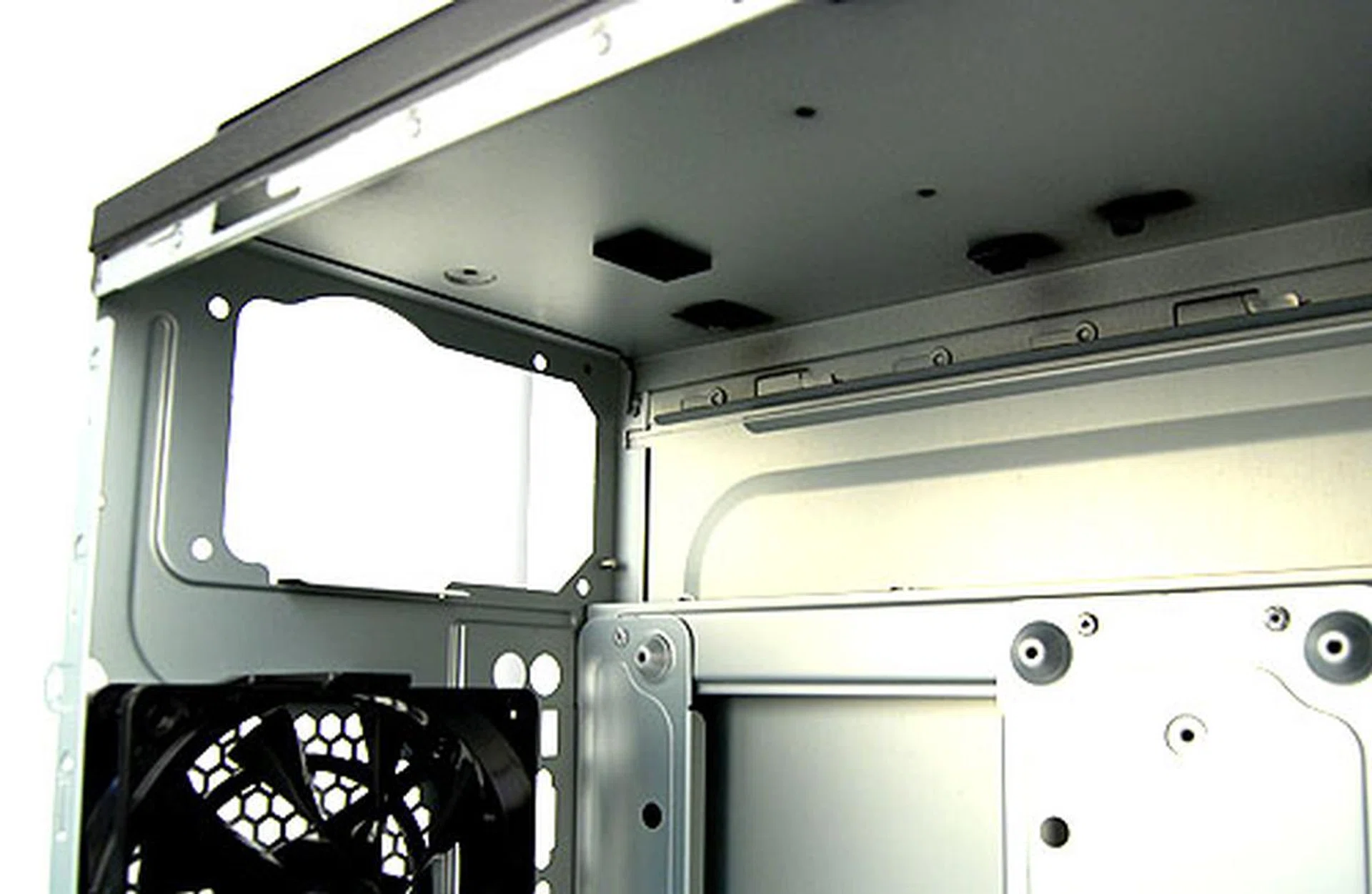 The PSU bay of the Thermaltake WingRS 301 is located on the top side. A small patch of foam is all there is to help cushion vibrations from the PSU.