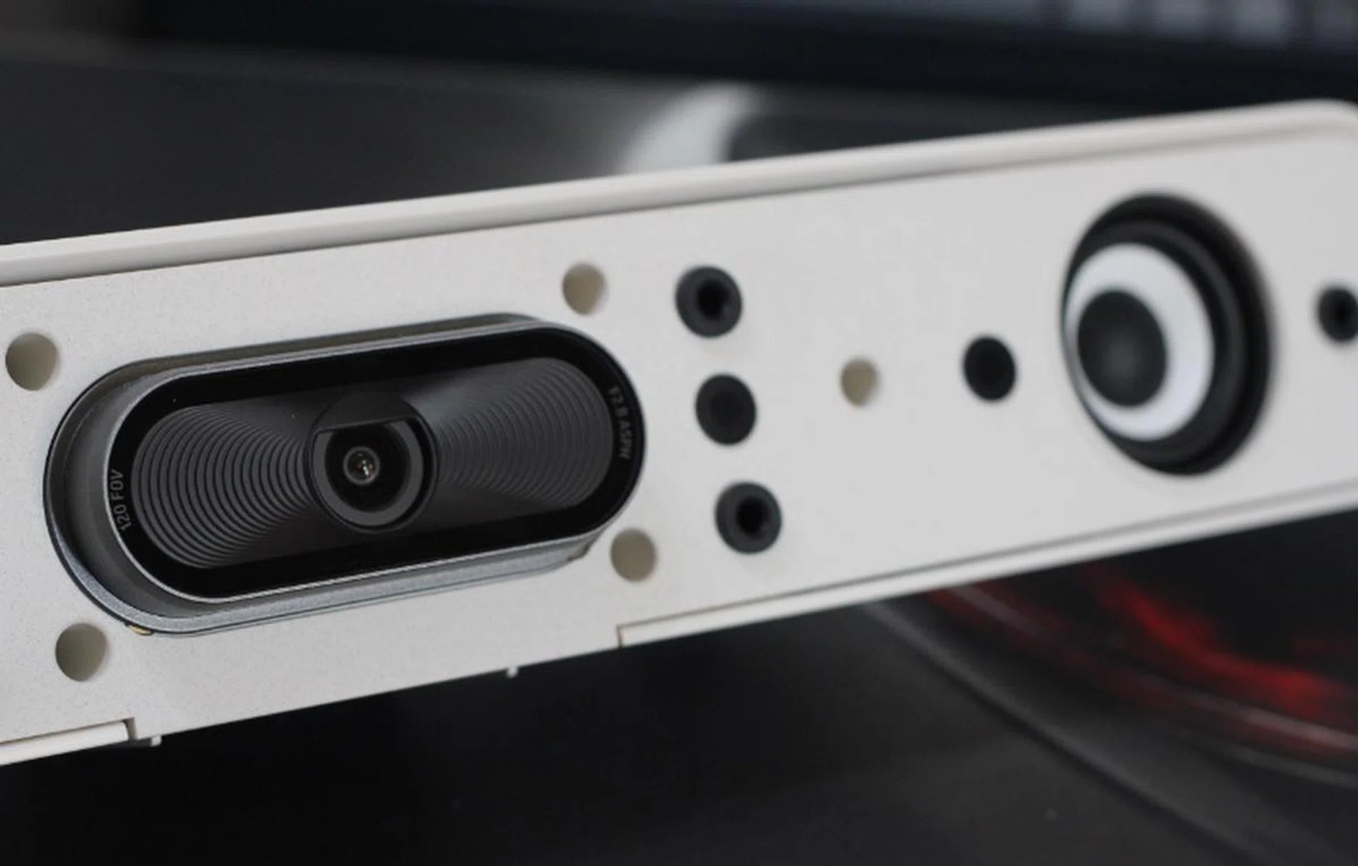 The speaker grille is fabric by design; a very nice touch that helps “soften” the outward appearance of the Studio X30 a little. In this image, you can see the single speaker, and two of the four MEMs microphones.