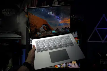 Surface Laptop 7 held in hand, splash image
