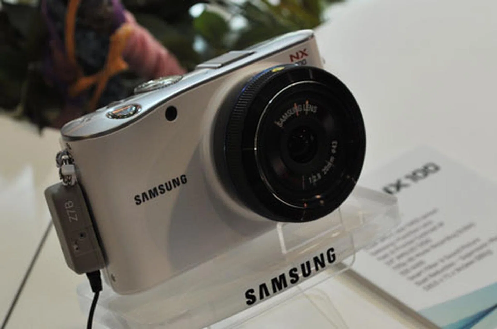 The NX100 is smaller and lighter than the NX10. It comes in white, black, brown and silver.