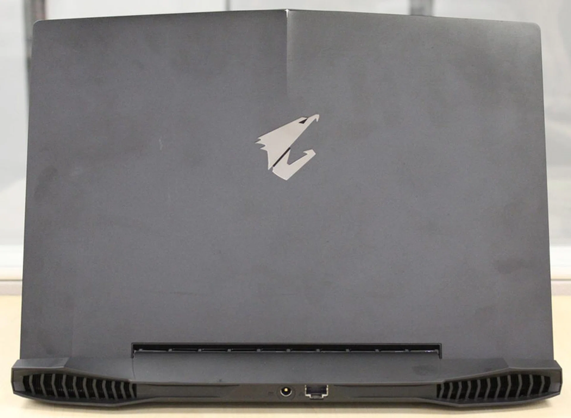 Despite the machine's slim dimensions, it has a full-sized Ethernet port at the rear. Note also the large exhaust vents on both ends for cooling.