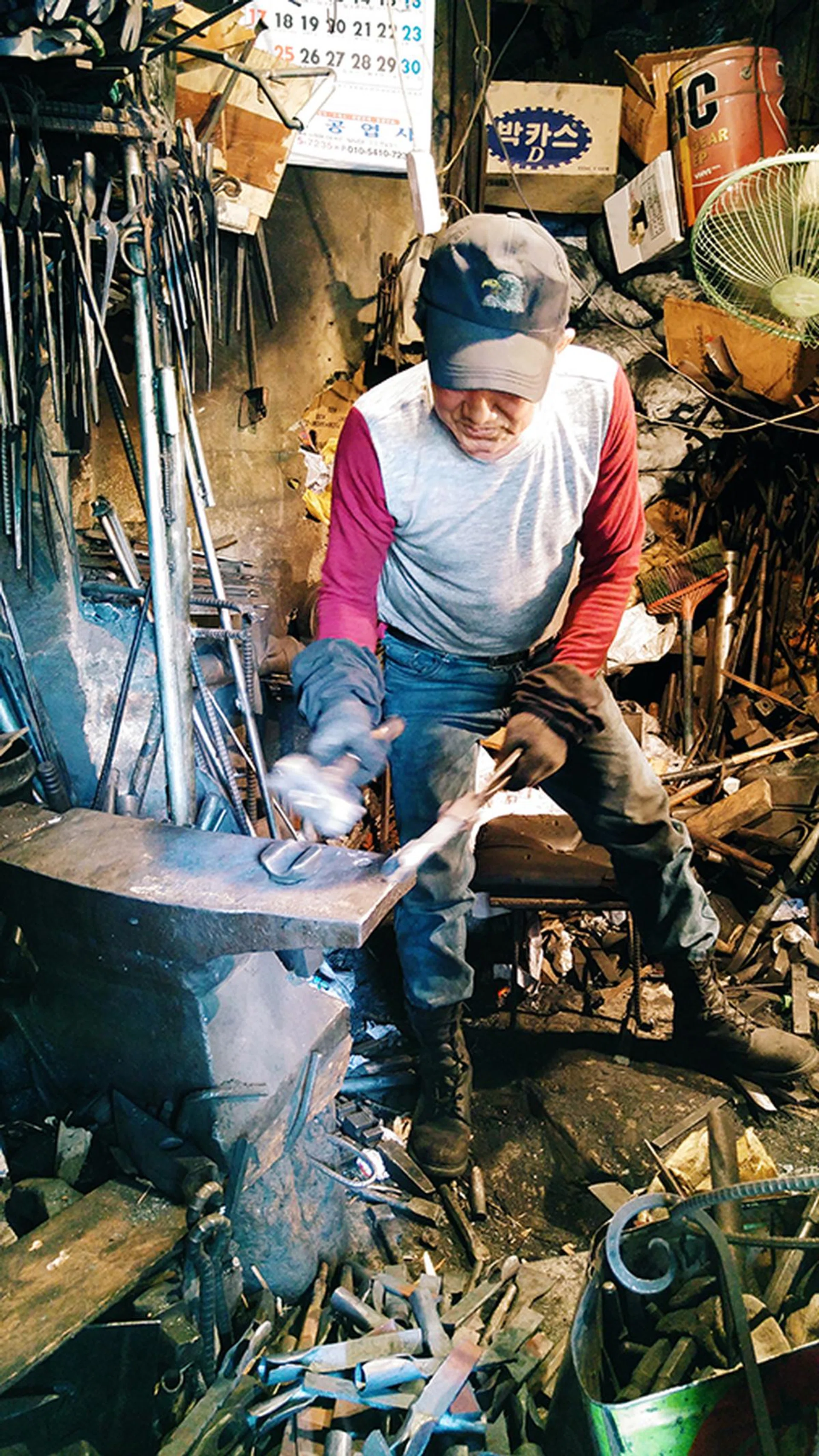 Portrait of metalsmith, 28mm at f/1.8, 1/30 sec, ISO 1150.