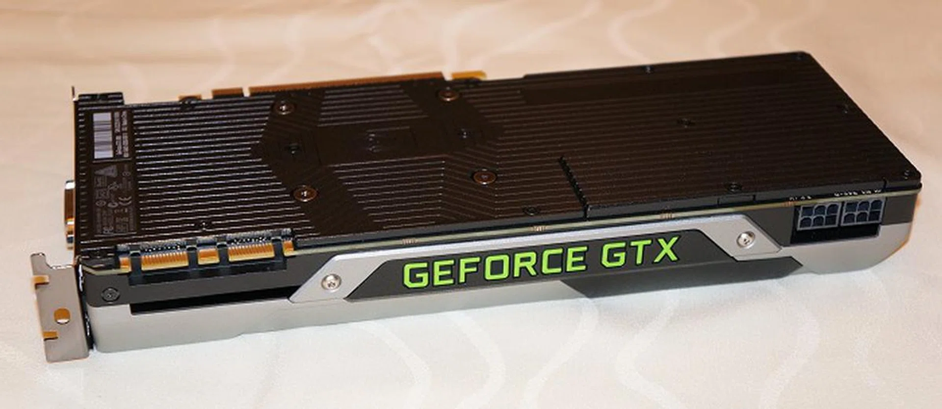 At the crown of the card, you'll see the lit GeForce GTX logo. Also note that the GeForce GTX 980 requires only dual 6-pin power connectors for its power needs. The card's rated TDP is only 165W and so NVIDIA recommends just a modest 500W PSU to power your average system with the new graphics card.