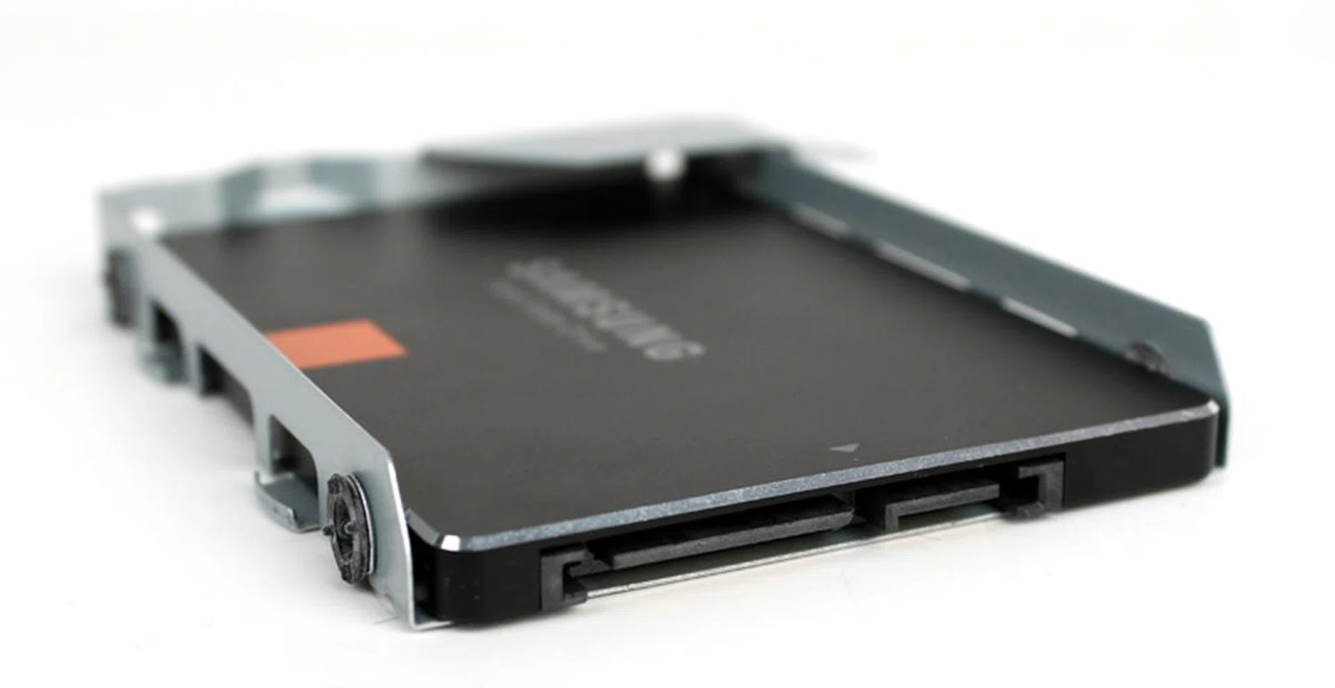 Put your new SSD into the chassis with the SATA connector pins facing down. If you're not sure, the SATA power connector should be closer to the left side. Line up the holes on the chassis and the drive and replace the screws to secure the drive in place.