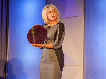 Diane Bryant, senior vice president and general manager of the Data Center Group at Intel showing off silicon wafer containing Intel's latest Xeon E5-2600 family of processors.