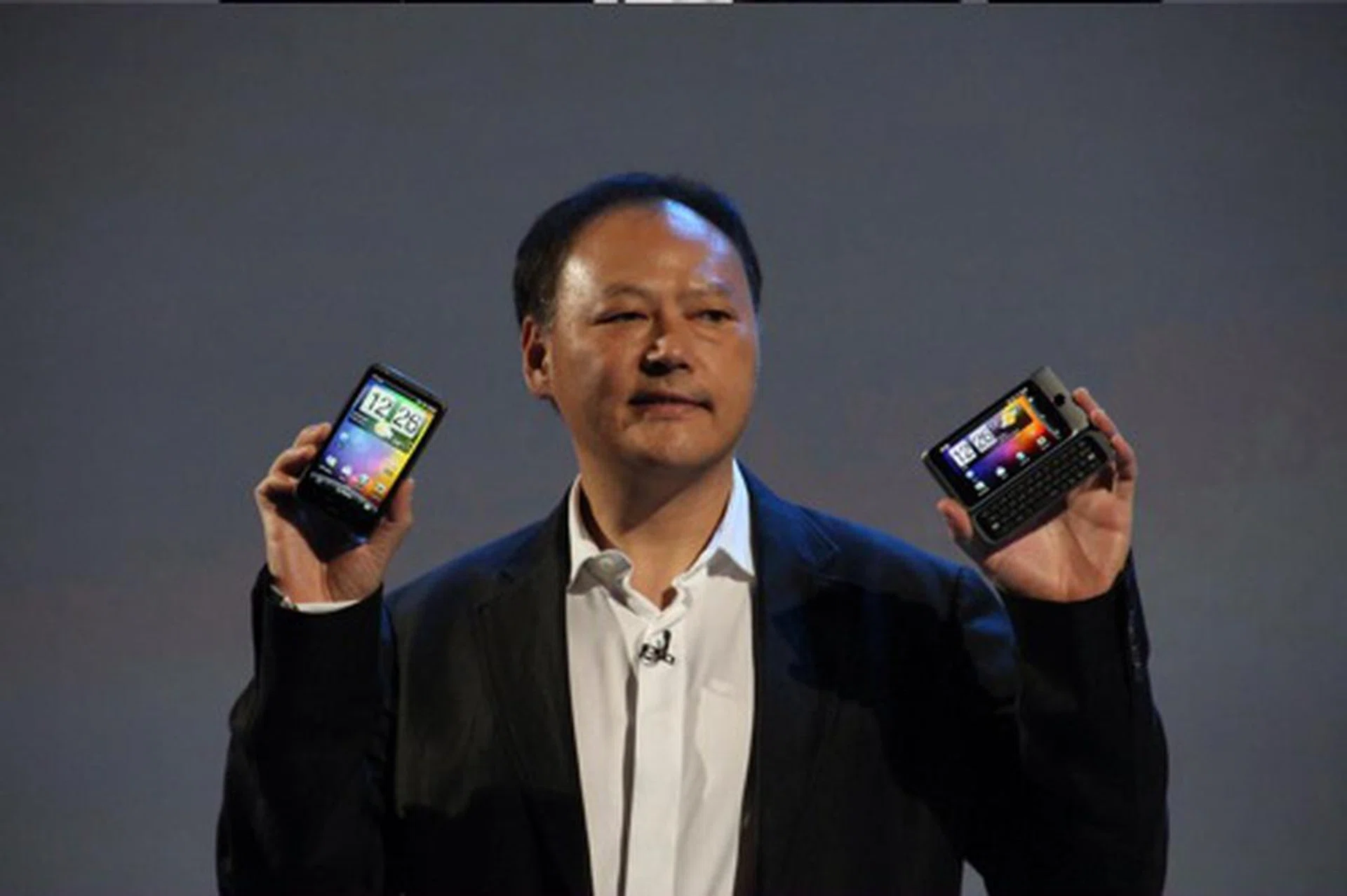 Peter Chou, Chief Executive Officer for HTC holds up the company's two new devices, the HTC Desire HD (left) and the HTC Desire Z (right).