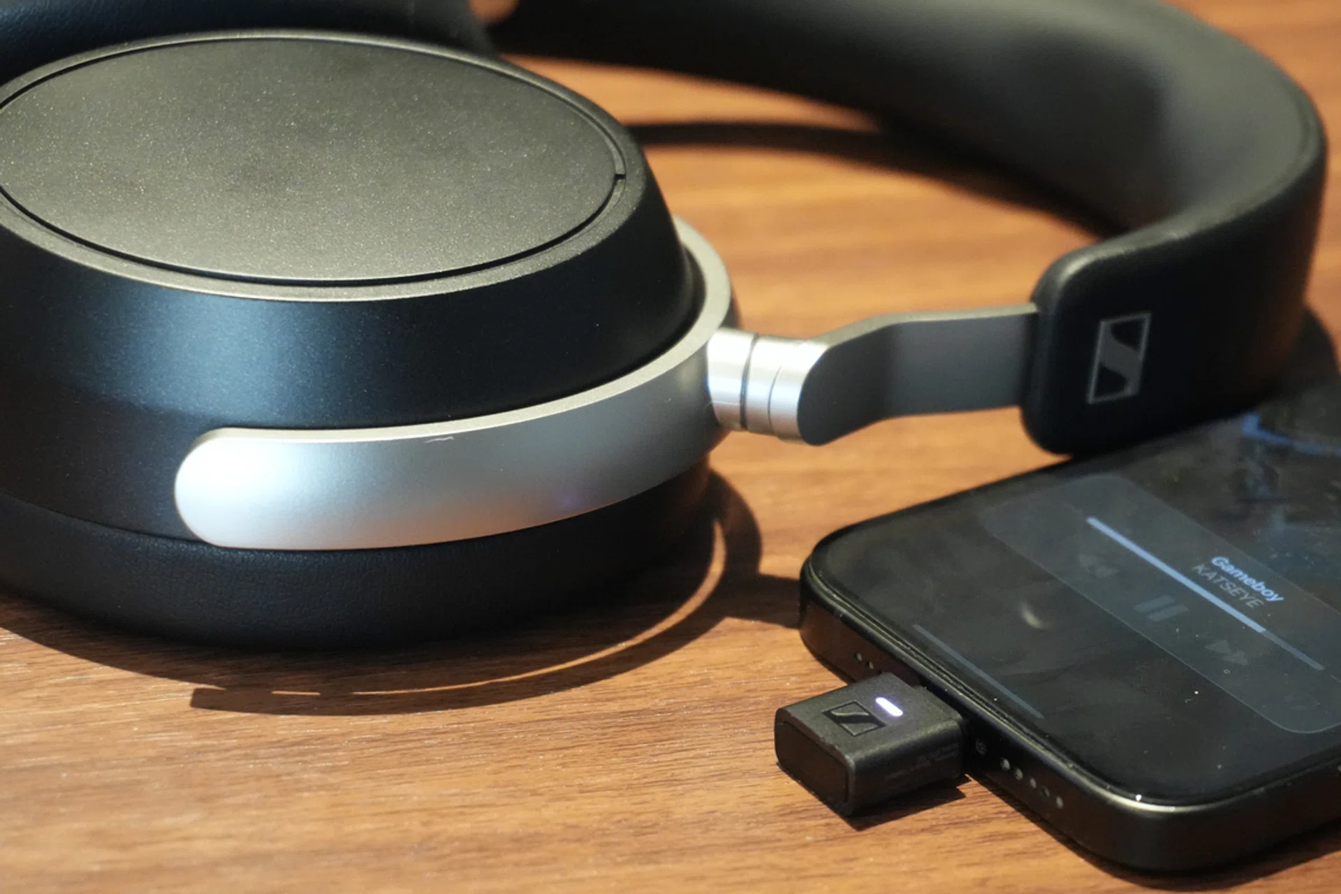 The Sennheiser HDB 630 laying flat while connected to an iPhone via the included BTD 700 transmitter. 