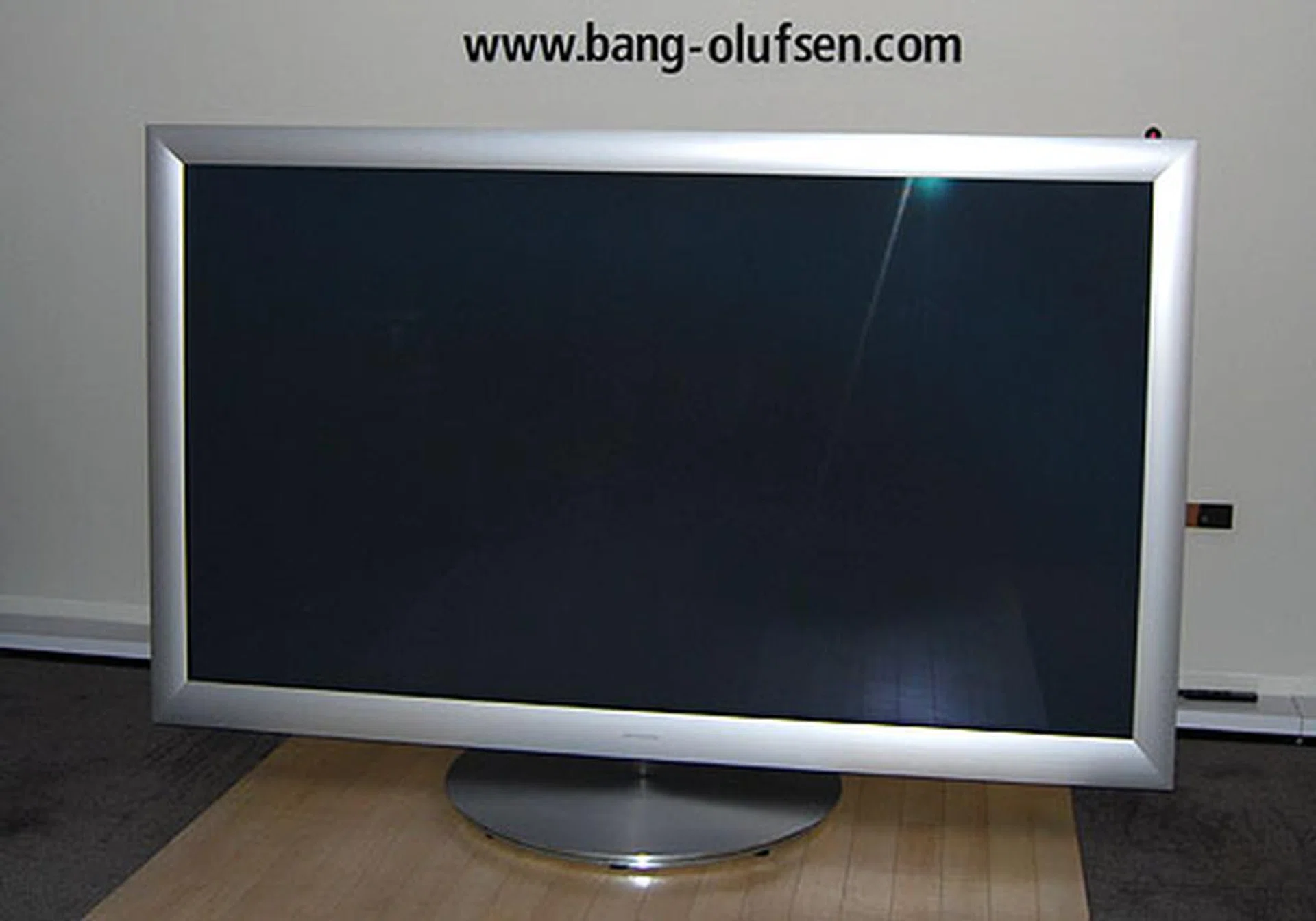 When the BeoVision 4-103 is turned off, it'll park itself by retracting its center speaker and lowering itself so as to, and we quote Bang & Olufsen, "reduce its prominence in the room." Right.