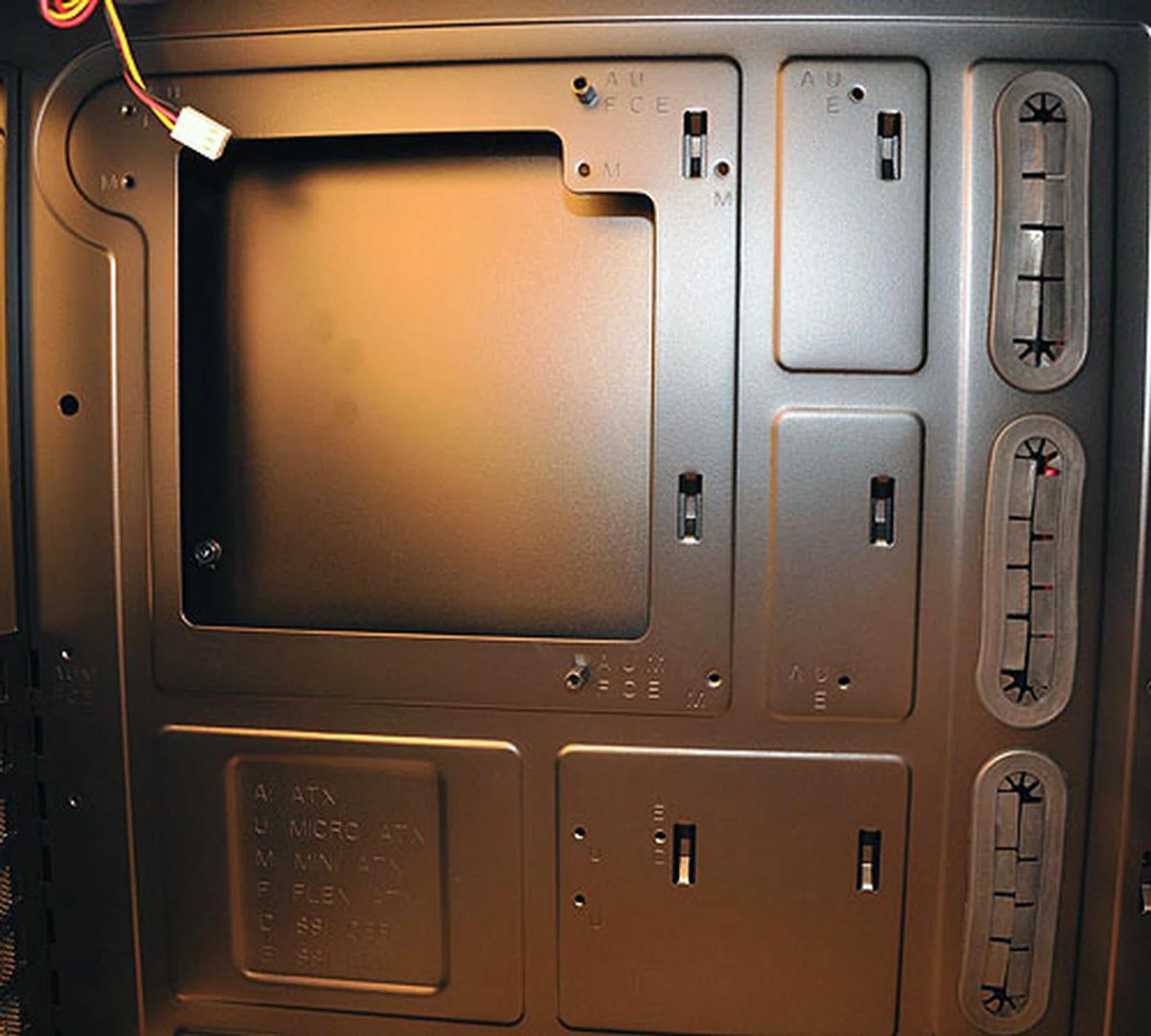 The mounting holes are marked according to the form factors and the cut-out space here allows easy access to the bottom of the motherboard, for when you need to change your cooler or processor.