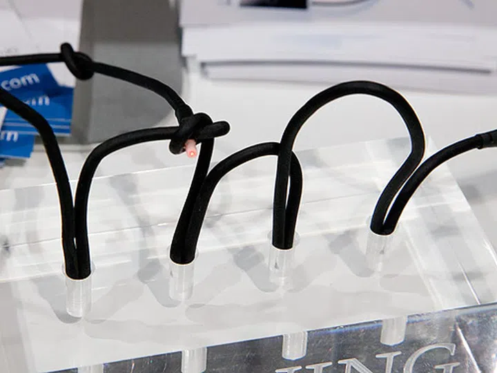 Kinks, knots and bends on the cable? Corning claims that the cable will continue to work, as demonstrated by the visible laser light at the end of the cable.
