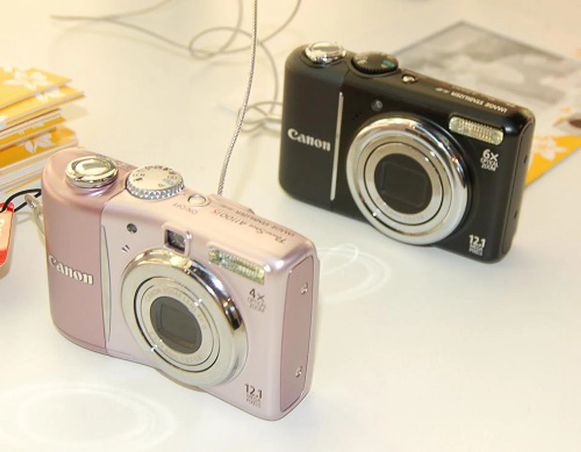  Here's the Canon Powershot A1100 IS and A2100 IS cameras in pink and black respectively.  