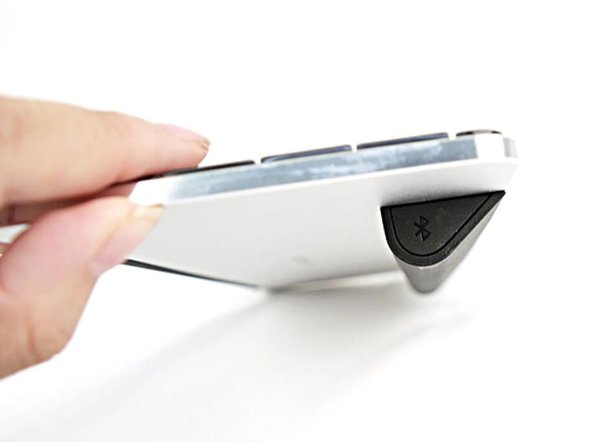 To switch on Bluetooth, simply look to the other side of the battery compartment for a Bluetooth icon. Long press it and wait for a small light to flicker on the keyboard.