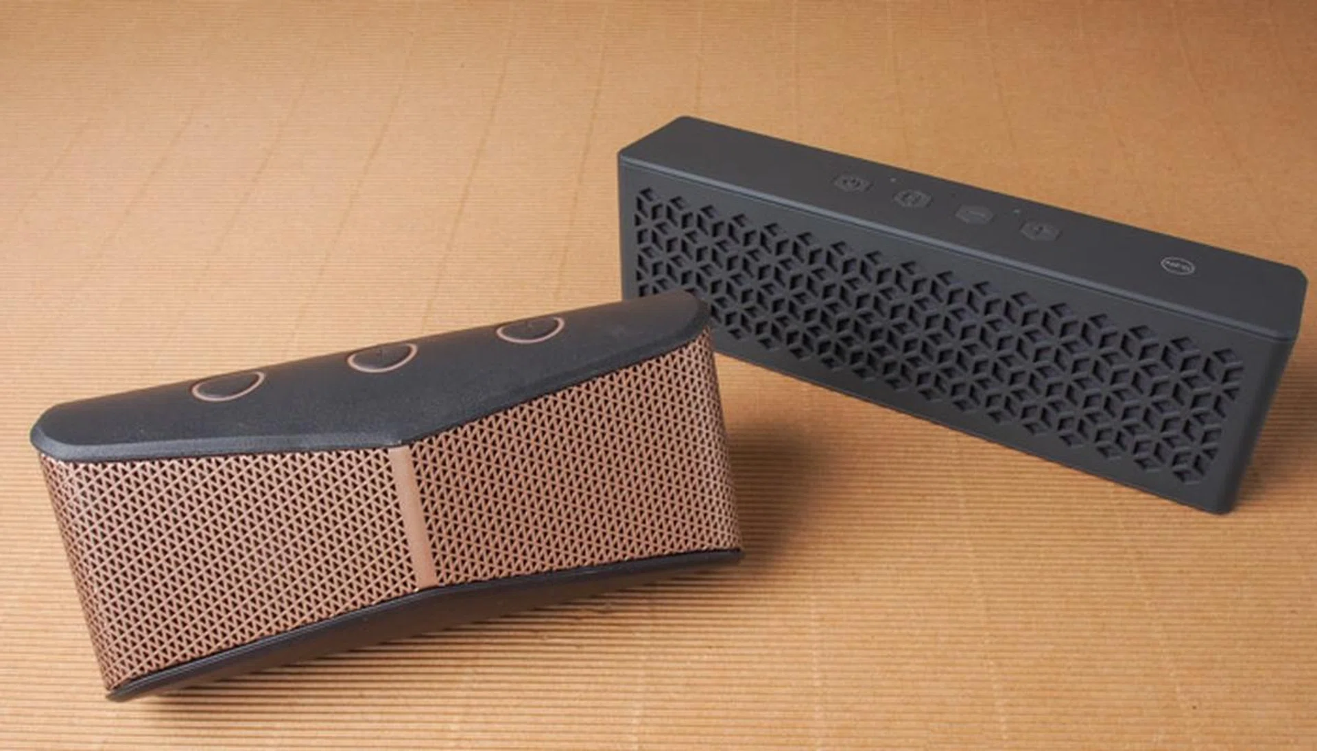 The wedge-shaped Logitech X300 and the more traditionally shaped Creative MuVo Mini.